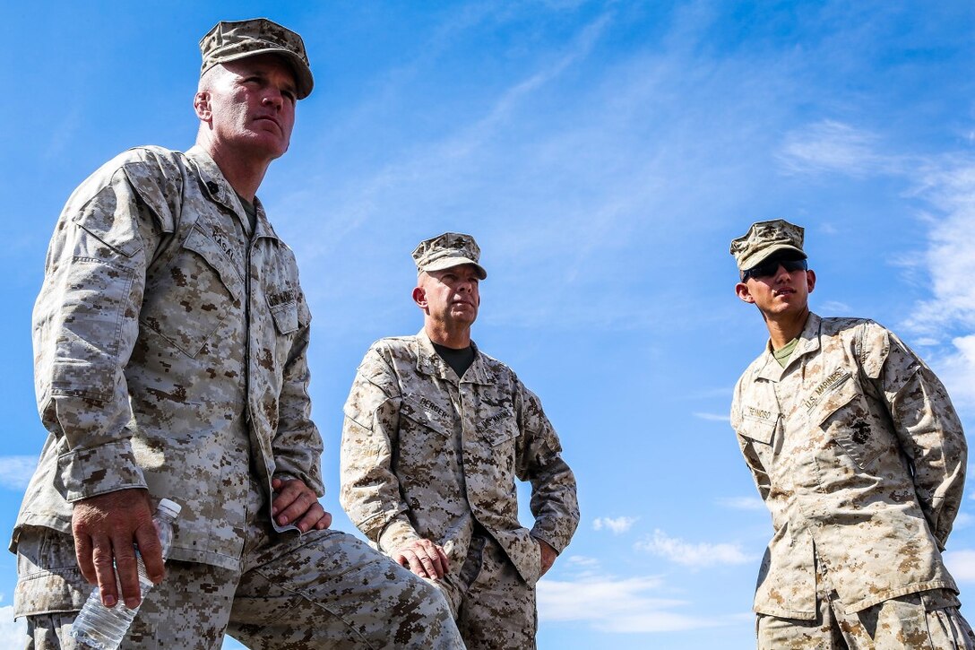 Sergeant Maj. Bradley Kasal, left, the sergeant major of I Marine Expeditionary Force, left, Lt. Gen. David H. Berger, center, commanding general of I MEF, and 1st. Lt. Bernardo Reynoso, communication officer with 1st Battalion, 7th Marine Regiment, observe Marines with 1/7 as they move into a training area during an Integrated Training Exercise aboard Marine Corps Air Ground Combat Center Twentynine Palms, Calif., Aug. 6, 2015.  ITX is conducted to enhance the integration and warfighting capability from all elements of the Marine Air Ground Task Force. Berger visited units currently training to support Special Purpose Marine Air Ground Task Force Crisis Response Central Command 16.1. (U.S Marine Corps Photo by Sgt. Rick Hurtado / Released).