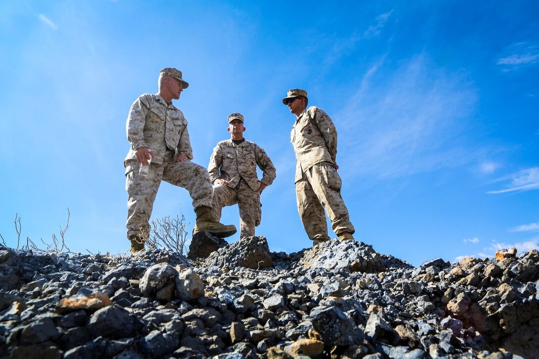 Sergeant Maj. Bradley Kasal, left, the sergeant major of I Marine Expeditionary Force, left, Lt. Gen. David H. Berger, center, commanding general of I MEF, and 1st. Lt. Bernardo Reynoso, communication officer with 1st Battalion, 7th Marine Regiment, observe Marines with 1/7 as they move into a training area during an Integrated Training Exercise aboard Marine Corps Air Ground Combat Center Twentynine Palms, Calif., Aug. 6, 2015.  ITX is conducted to enhance the integration and warfighting capability from all elements of the Marine Air Ground Task Force. Berger visited units currently training to support Special Purpose Marine Air Ground Task Force Crisis Response Central Command 16.1. (U.S Marine Corps Photo by Sgt. Rick Hurtado / Released).