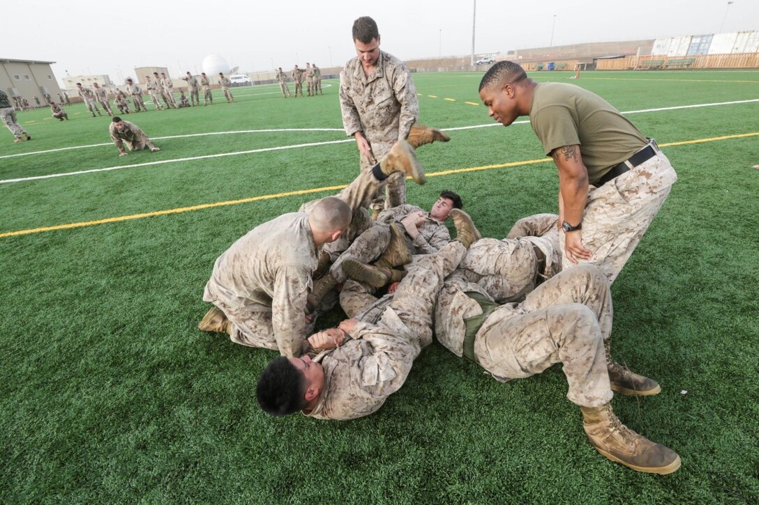 CAMP LEMONNIER, Djibouti (Aug. 5, 2015)  U.S. Marines with India Company, Battalion Landing Team 3rd Battalion, 1st Marine Regiment, 15th Marine Expeditionary Unit, practice unarmed combat techniques. The Marines combine the physical training and teaching techniques to build small-unit leadership among their young Marines.  Elements of the 15th MEU are ashore in Djibouti for sustainment training to maintain and enhance the skills they developed during their pre-deployment training period.  The 15th MEU is currently deployed in support of maritime security operations and theater security cooperation efforts in the U.S. 5th Fleet area of operations. (U.S. Marine Corps photo by Sgt. Jamean Berry/Released)