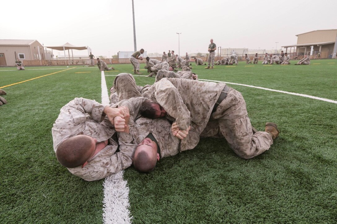 CAMP LEMONNIER, Djibouti (Aug. 5, 2015)  U.S. Marines with India Company, Battalion Landing Team 3rd Battalion, 1st Marine Regiment, 15th Marine Expeditionary Unit, practice unarmed combat techniques. The Marines combine the physical training and teaching techniques to build small-unit leadership among their young Marines.  Elements of the 15th MEU are ashore in Djibouti for sustainment training to maintain and enhance the skills they developed during their pre-deployment training period.  The 15th MEU is currently deployed in support of maritime security operations and theater security cooperation efforts in the U.S. 5th Fleet area of operations. (U.S. Marine Corps photo by Sgt. Jamean Berry/Released)