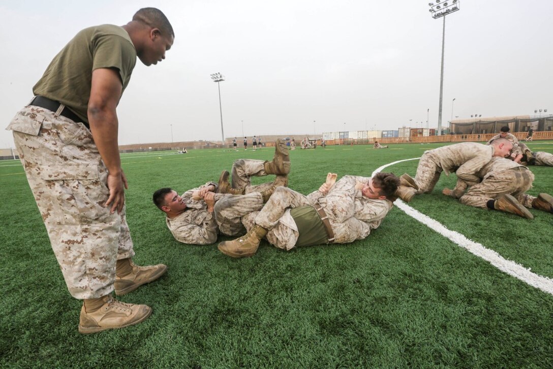 CAMP LEMONNIER, Djibouti (Aug. 5, 2015)  U.S. Marines with India Company, Battalion Landing Team 3rd Battalion, 1st Marine Regiment, 15th Marine Expeditionary Unit, practice unarmed combat techniques. The Marines combine the physical training and teaching techniques to build small-unit leadership among their young Marines.  Elements of the 15th MEU are ashore in Djibouti for sustainment training to maintain and enhance the skills they developed during their pre-deployment training period.  The 15th MEU is currently deployed in support of maritime security operations and theater security cooperation efforts in the U.S. 5th Fleet area of operations. (U.S. Marine Corps photo by Sgt. Jamean Berry/Released)