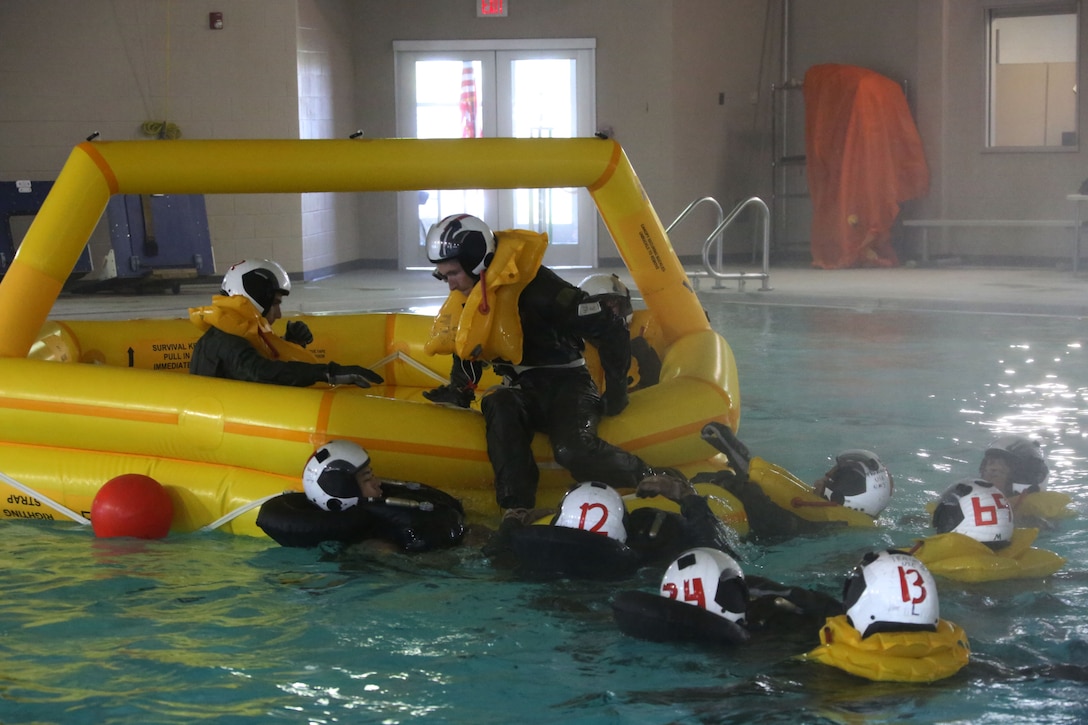 Marines simulated resque protocol during water survival training at Marine Corps Air Station Cherry Point, North Carolina, July 28, 2015. The Aviation Survival Training Center is the only water survival facility on any Marine Corps installation on the East Coast. Naval aviators are given classes on protocol and the gear they use in case of an emergency on an aircraft. The skills they learn in ASTC ensure 2nd Marine Aircraft Wing, its aviators and crew members are qualified and maintain the highest state of readiness.