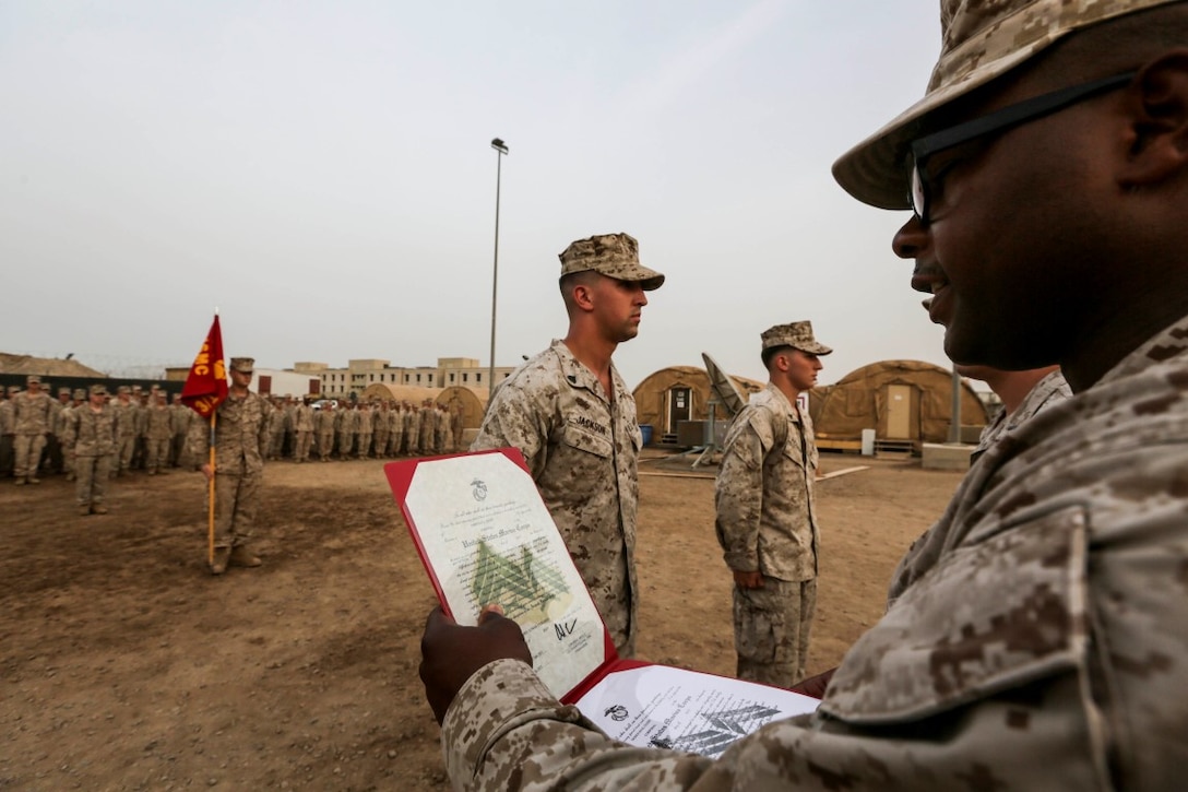 CAMP LEMONNIER, Djibouti (Aug. 2, 2015) U.S. Marine 1st Sgt. Sasha Dix reads a Marine Corps noncommissioned officer promotion warrant during a promotion ceremony.  Dix is the company first sergeant for India Company, Battalion Landing Team 3rd Battalion, 1st Marine Regiment, 15th Marine Expeditionary Unit. Elements of the 15th MEU are ashore in Djibouti for sustainment training to maintain and enhance the skills they developed during their pre-deployment training period.  The 15th MEU is currently deployed in support of maritime security operations and theater security cooperation efforts in the U.S. 5th Fleet area of operations. (U.S. Marine Corps photo by Sgt. Jamean Berry/Released)