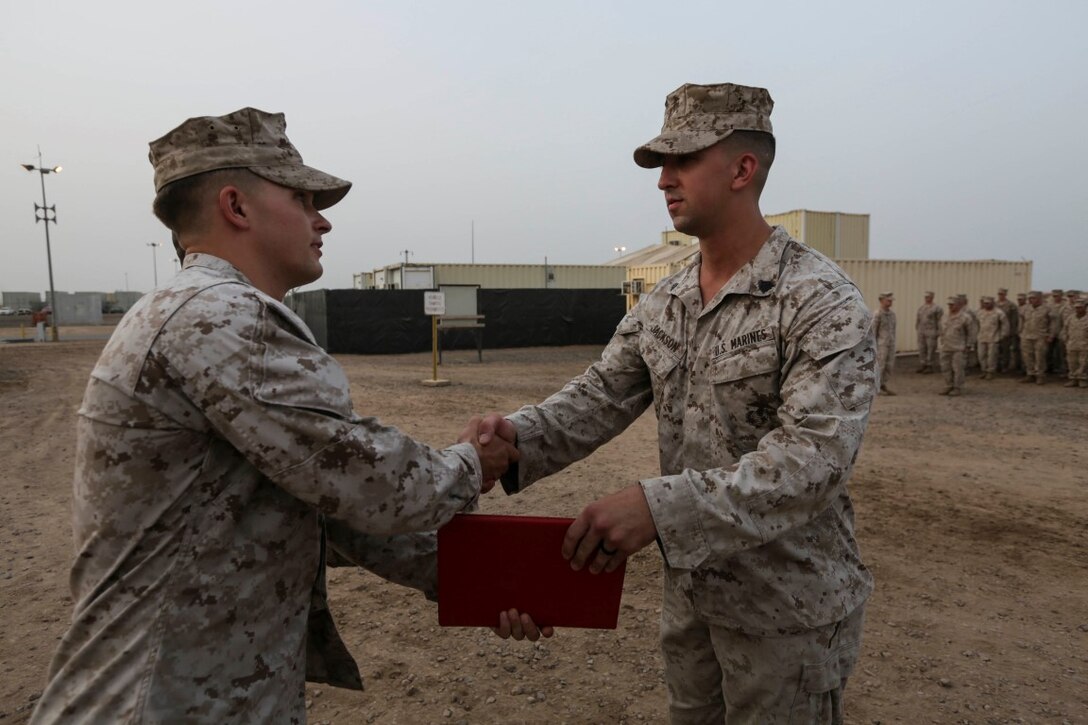 CAMP LEMONNIER, Djibouti (Aug. 2, 2015) U.S. Marine 1st Lt. Sam Carlson congratulates Sgt. Ryan Jackson during a promotion ceremony. Carlson is the executive officer and Jackson is a squad leader, both with India Company, Battalion Landing Team 3rd Battalion, 1st Marine Regiment, 15th Marine Expeditionary Unit. Jackson was meritoriously promoted to corporal while deployed wit hthe 15th MEU. Elements of the 15th MEU are ashore in Djibouti for sustainment training to maintain and enhance the skills they developed during their pre-deployment training period.  The 15th MEU is currently deployed in support of maritime security operations and theater security cooperation efforts in the U.S. 5th Fleet area of operations. (U.S. Marine Corps photo by Sgt. Jamean Berry/Released)