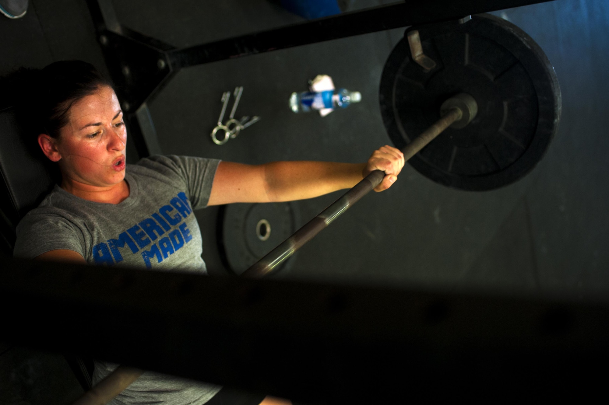 U.S. Air Force Airman 1st Class Sarah M. Bracy, 315th Training Squadron student, performs a bench press at a crossfit gym in San Angelo, Texas, Aug. 6, 2015. Almost diagnosed with diabetes, Bracy started lifting 10 years ago to better her life. (U.S. Air Force photo by Senior Airman Scott Jackson/released)