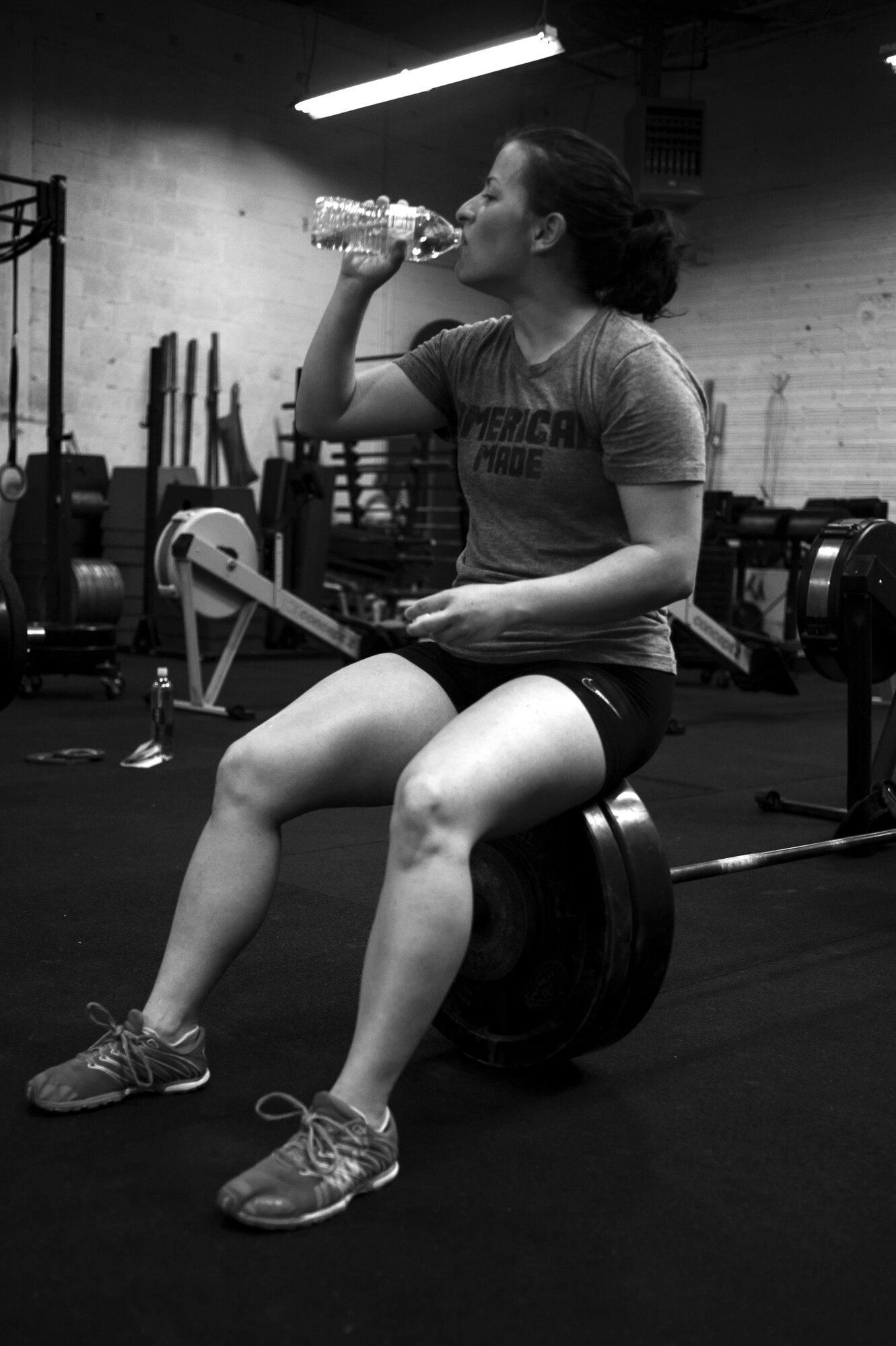 U.S. Air Force Airman 1st Class Sarah M. Bracy, 315th Training Squadron student, rests after lifting at a crossfit gym in San Angelo, Texas, Aug. 6, 2015. Almost diagnosed with diabetes, Bracy started lifting 10 years ago to better her life. (U.S. Air Force photo by Senior Airman Scott Jackson/released)