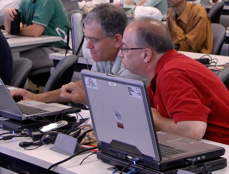 Sal Fanelli (right), assistant product manager for engineering, and Richard Hardy, safety lead, at Marine Corps Systems Command, review data during the modeling and simulation course held in July at Marine Corps Base Quantico, Virginia. 