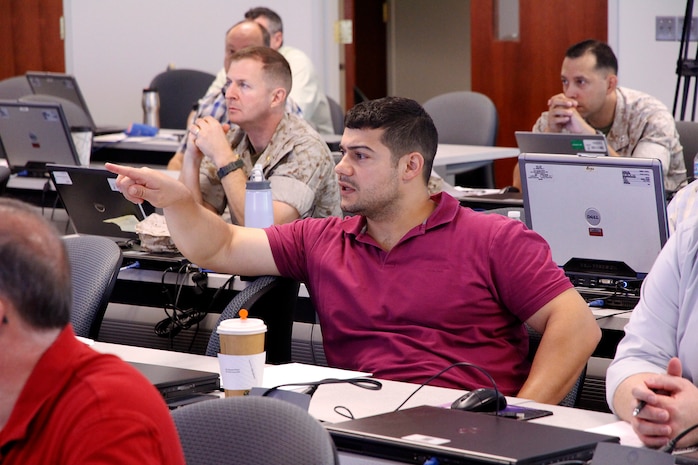 Michael Martha, systems engineer with Light Tactical Vehicles in Program Executive Officer Land Systems, asks a question during the modeling and simulation course held in July at Marine Corps Base Quantico, Virginia. 