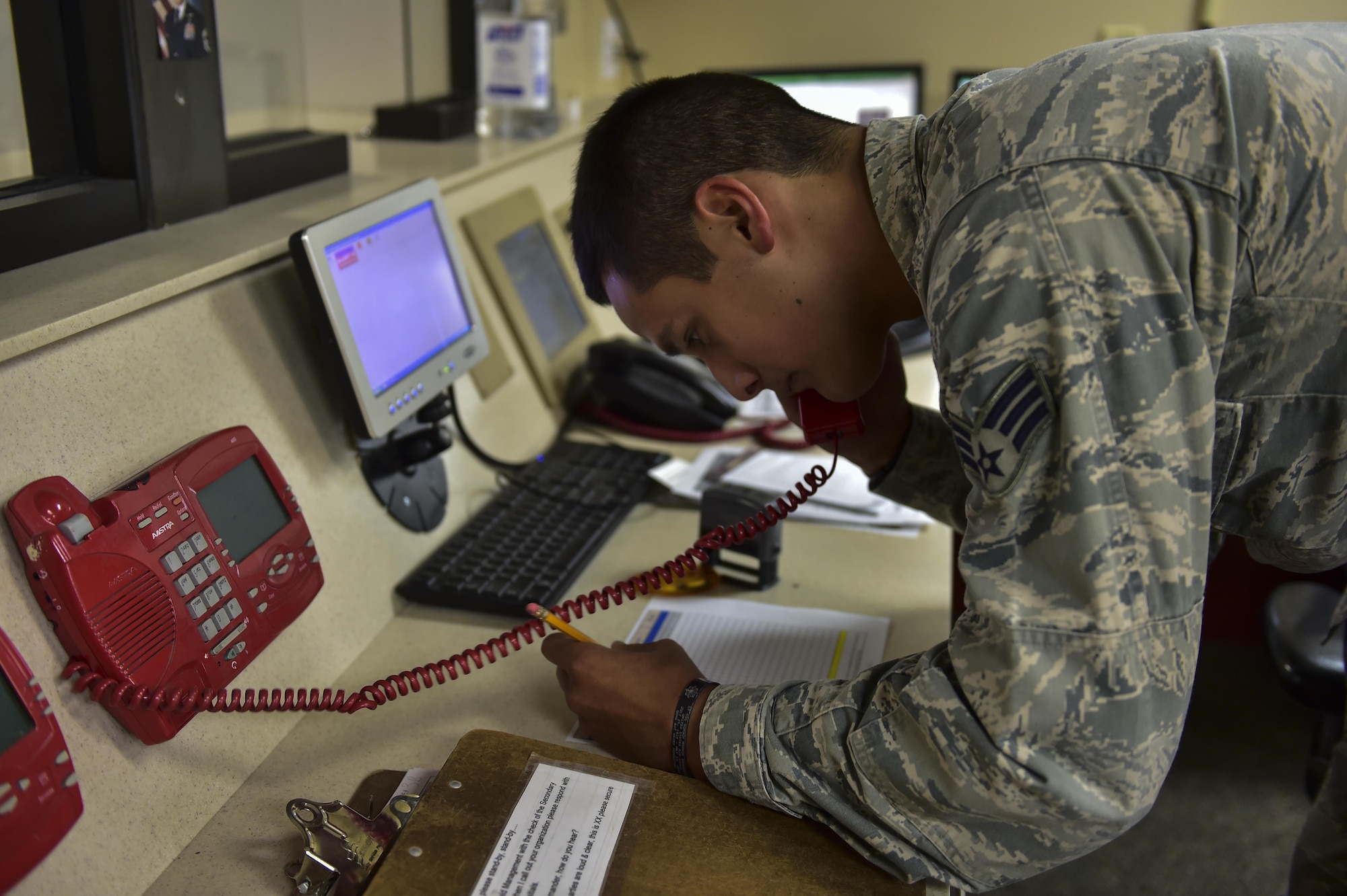 Senior Airman David Rios, 1st Special Operations Support Squadron airfield management operations shift leader, tests  the secondary crash alarm system on Hurlburt Field, Fla., Aug. 4, 2015. The SCAS is a phone system that dials out to multiple emergency agencies on base when in-flight emergencies, emergency landings or ground emergencies occur. (U.S. Air Force photo/Senior Airman Jeff Parkinson)