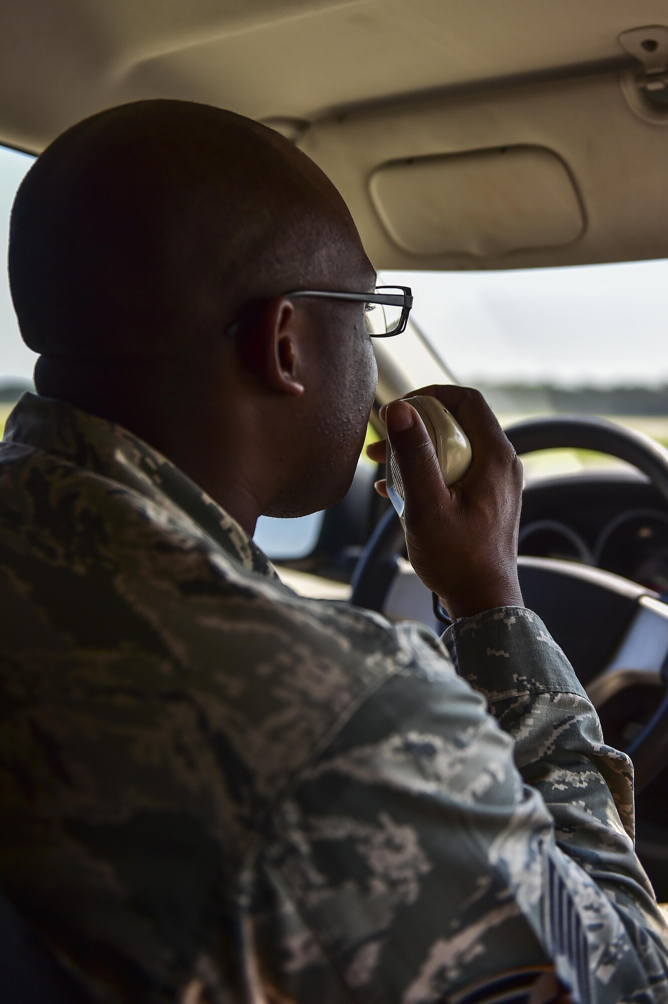 Tech. Sgt. Dominique Bonapart, 1st Special Operations Support Squadron airfield management operations NCO in-charge, requests approval to move onto the active runway during an airfield check on Hurlburt Field, Fla., Aug. 4, 2015. Airfield checks are performed every two hours to remove any foreign object debris that might end up on the airfield as aircraft take off and land. (U.S. Air Force photo/Senior Airman Jeff Parkinson)