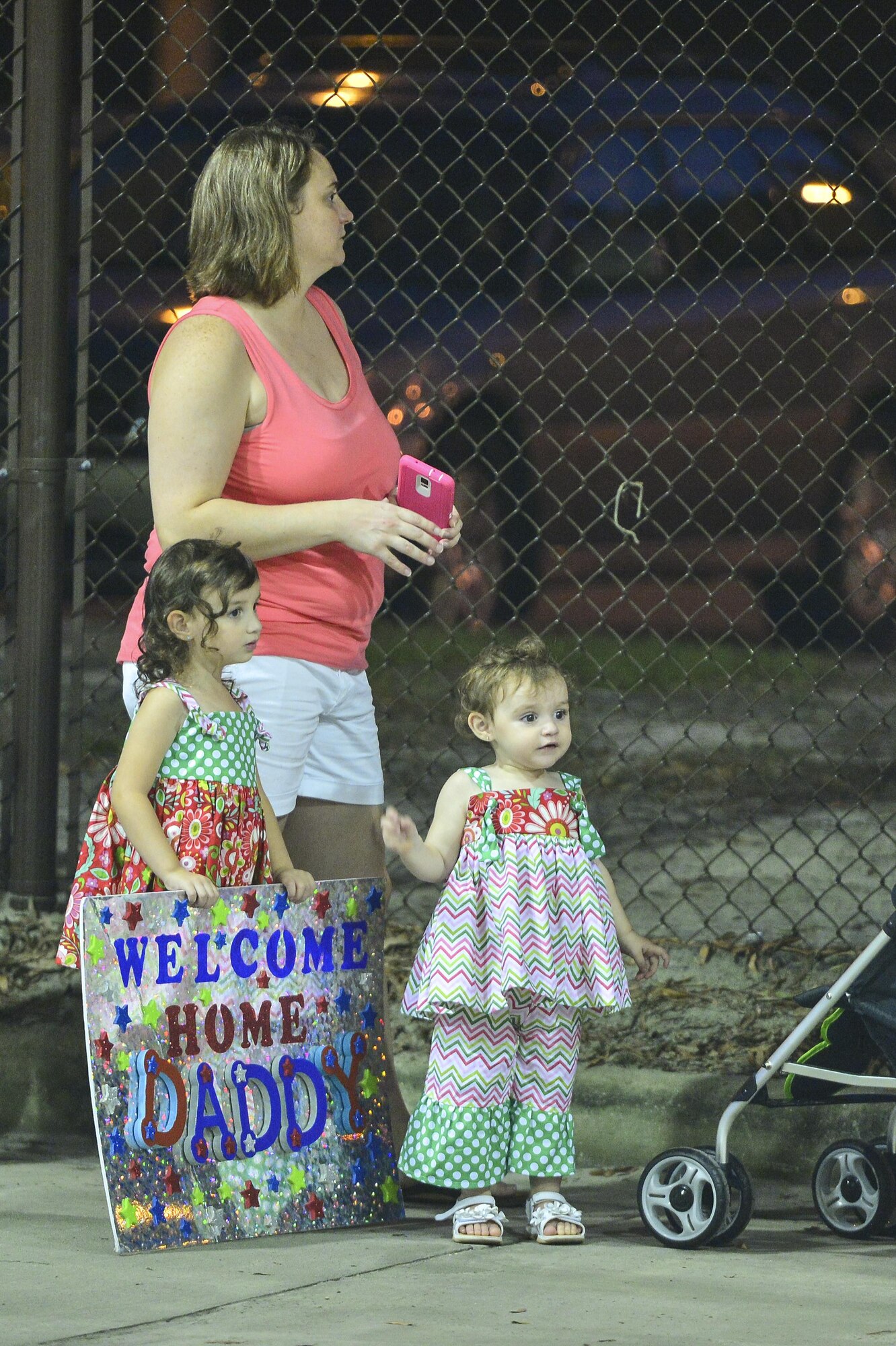 The family of Staff Sgt. Timothy Wagster, 1st Special Operations Component Maintenance Squadron, waits for him to return from a deployment during Operation Homecoming on Hurlburt Field, Fla., Aug. 7, 2015. Wagster is one of 667 Airmen returning from a recent deployment overseas. (U.S. Air Force photo/Senior Airman Jeff Parkinson)