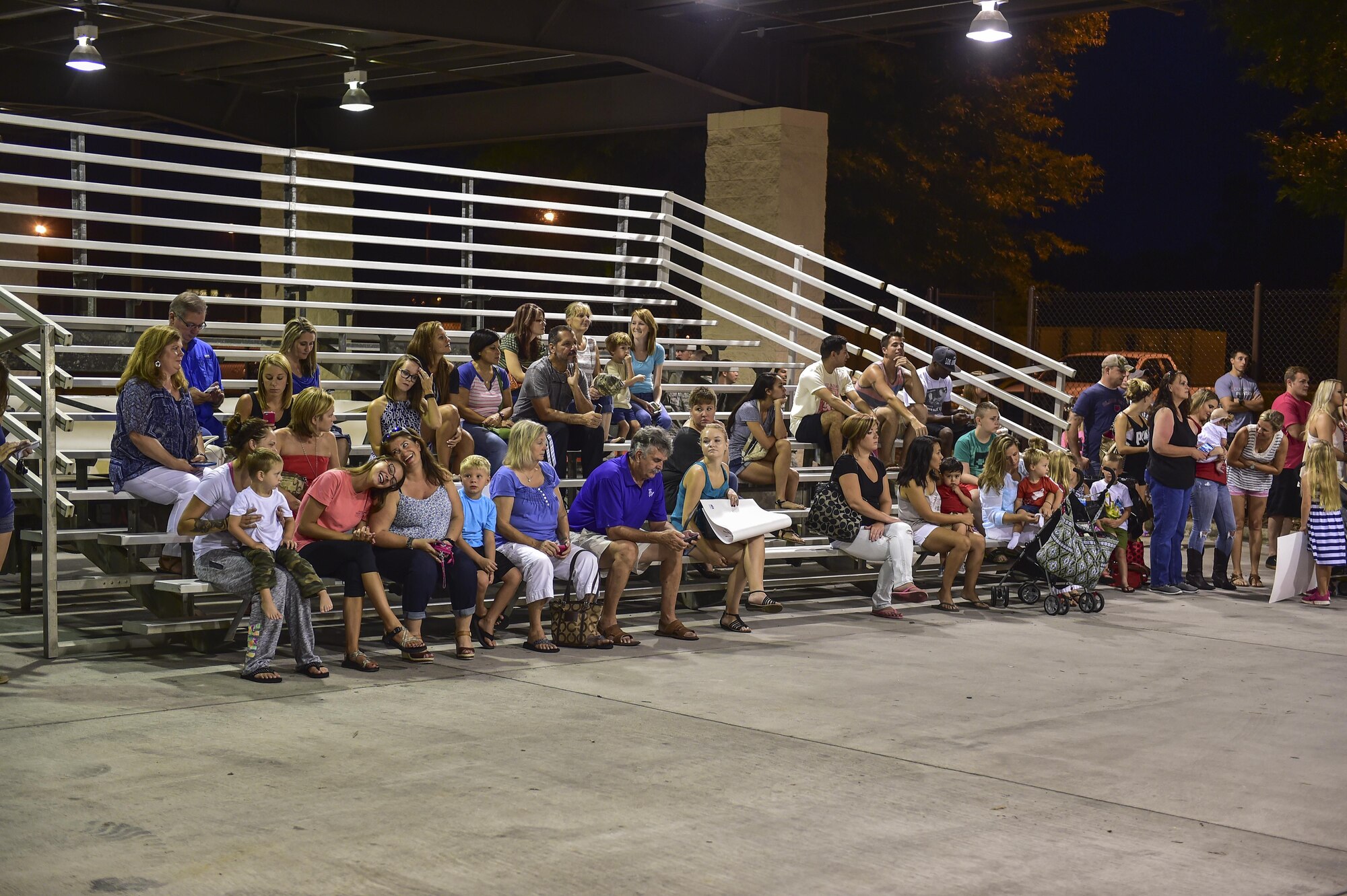 Family members wait for the returning deployed members during Operation Homecoming on Hurlburt Field, Fla., Aug. 7, 2015. Operation Homecoming is a program created to welcome home Airmen returning from a recent deployment. (U.S. Air Force photo/Senior Airman Jeff Parkinson)