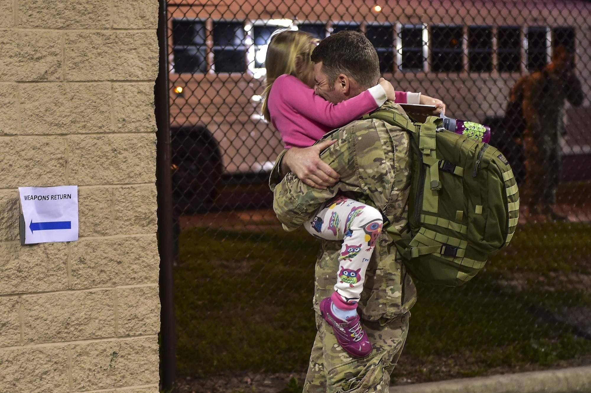 Maj. Ian Frady, Air Force Special Operations Command plans and programming, hugs his daughter after returning home from a recent deployment during Operation Homecoming on Hurlburt Field, Fla., Aug. 7, 2015. Operation Homecoming is a program created to welcome home Airmen returning from a recent deployment.  (U.S. Air Force photo/Senior Airman Jeff Parkinson)