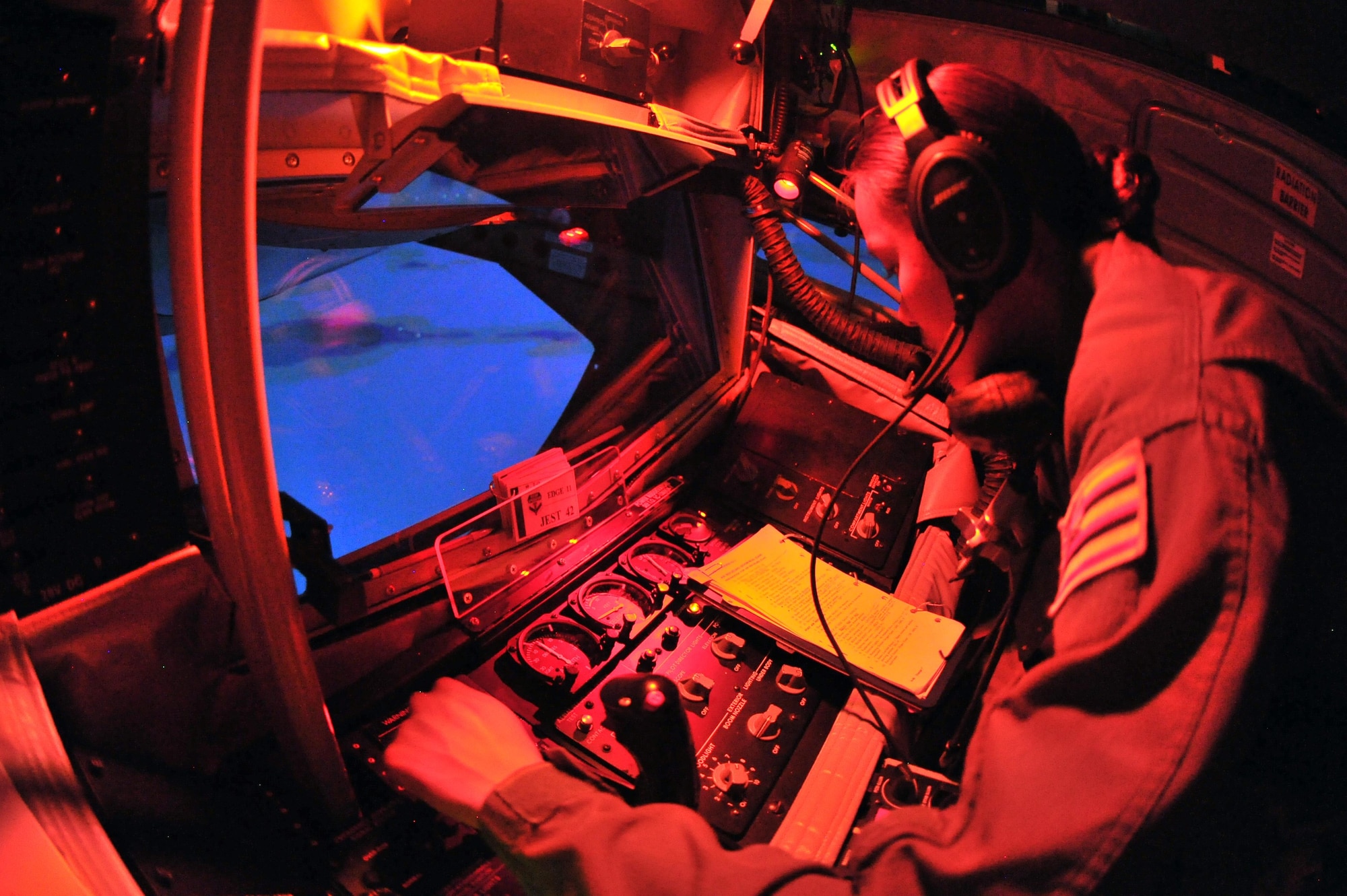 U.S. Air Force Senior Airman Mary Claire Bolo, 203rd Air Refueling Squadron boom operator student, Hawaii Air National Guard, prepares to make contact with a receiving aircraft inside a U.S. Air Force KC-135 Stratotanker refueling aircraft Boom Operator Weapons System Trainer at Altus Air Force Base, Oklahoma. Training in the BOWST gives students a chance to learn proper operation and troubleshooting techniques without the risks involved with flying. (U.S. Air Force photo by Senior Airman Dillon Davis)
