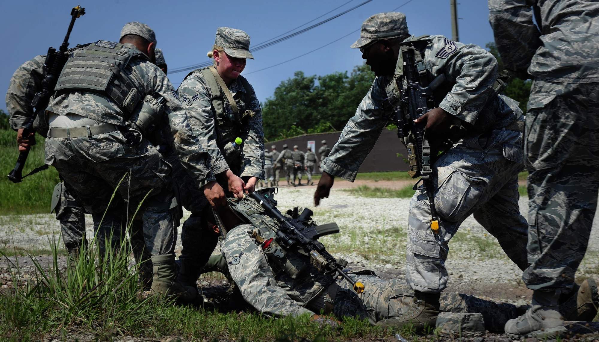 U.S. Air Force Airmen from the 8th Security Forces Squadron participate in a tactical combat casualty care scenario during a three day combat readiness training exercise at Kunsan Air Base, Republic of Korea, August 3, 2015. Integrating Airmen of all ranks with Republic of Korea air force members in quarterly CRTs strengthens teamwork to provide a higher level of safety and security of the Wolf Pack. (U.S. Air Force photo by Staff Sgt. Nick Wilson/Released)
