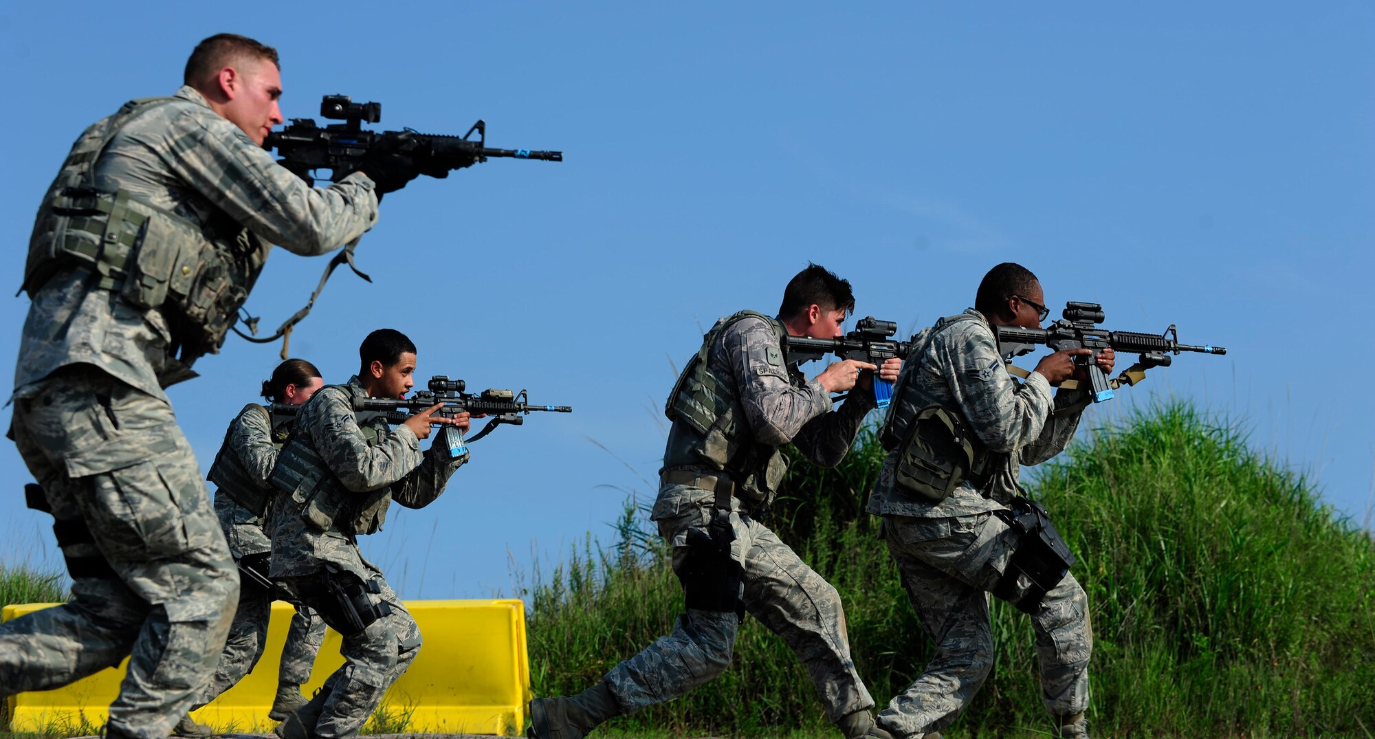 U.S. Air Force Airmen from the 8th Security Forces Squadron participate in a shoot, move and communicate drill during a three day combat readiness training exercise at Kunsan Air Base, Republic of Korea, August 3, 2015. Airmen covered topics including mounted and dismounted operations, individual and small unit tactics, land navigation, shoot-move and communication, tactical communications, enemy prisoner of war procedures, self-aid buddy care and additional battlefield curriculums. (U.S. Air Force photo by Staff Sgt. Nick Wilson/Released)