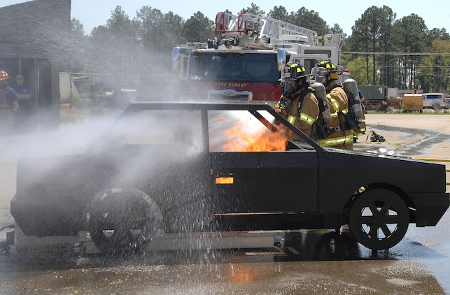 Firefighters Megan Cornell (left) and Tim Wright with Fire and Emergency Services, Marine Corps Logistics Base Albany, attack a controlled vehicle fire during an exercise aboard MCLB Albany, recently. Cornell is the recipient of MCLB Albany’s Firefighter of the Year Award for 2015; Public Safety Division Civilian Employee of the Year for 2015 and the Marine Corps Firefighter of the Year Award for 2015.
