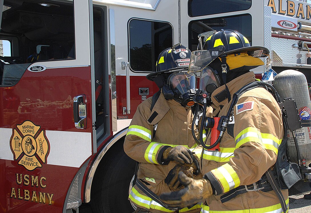 Firefighters Megan Cornell (left) and Tim Wright with Fire and Emergency Services, Marine Corps Logistics Base Albany, discuss their strategy about how to attack a controlled vehicle fire during an exercise, recently. Cornell is the recipient of MCLB Albany’s Firefighter of the Year Award for 2015; Public Safety Division Civilian Employee of the Year for 2015 and the Marine Corps Firefighter of the Year Award for 2015. 