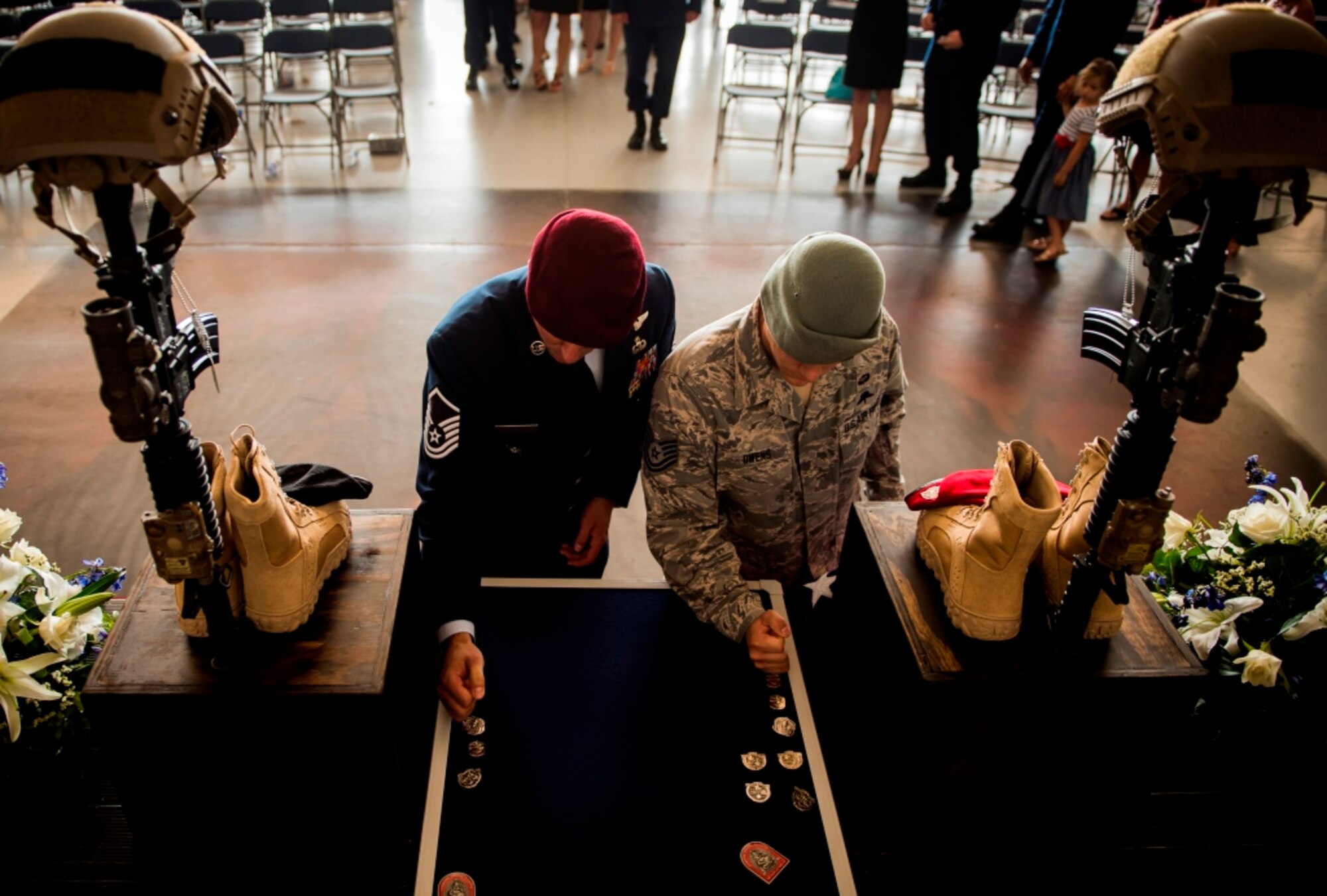 Fellow Special Tactics Airmen pound their beret flashes into a board following a memorial ceremony for Tech Sgt. Timothy Officer Jr., a tactical air control party Airman, and Tech Sgt. Marty Bettelyoun, a combat controller, at Hurlburt Field, Fla., Aug. 7, 2015. Officer and Bettelyoun, both assigned to the 24th Special Operations Wing, died from injuries sustained during an freefall training accident on Eglin Range, Fla., Aug. 3, 2015. (U.S. Air Force photo by Senior Airman Christopher Callaway/Released)
