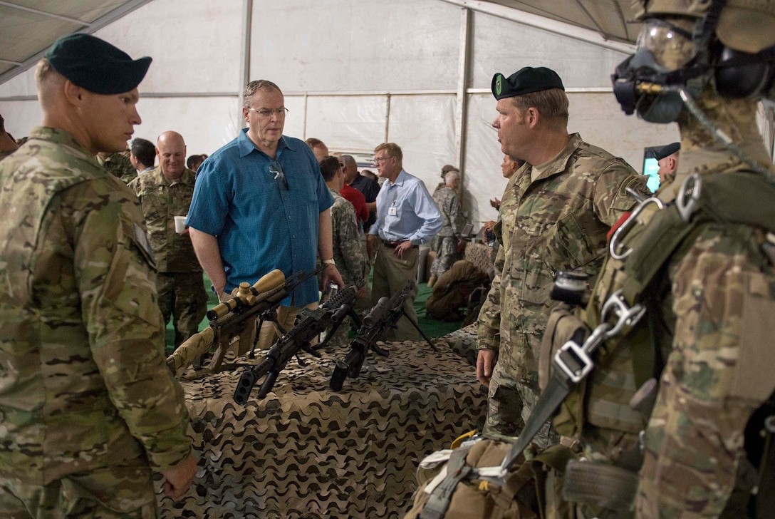 Deputy Defense Secretary Bob Work, center, talks with Army Special Forces members  as they display some of their equipment at Fort Irwin, Calif., Aug. 5, 2015.