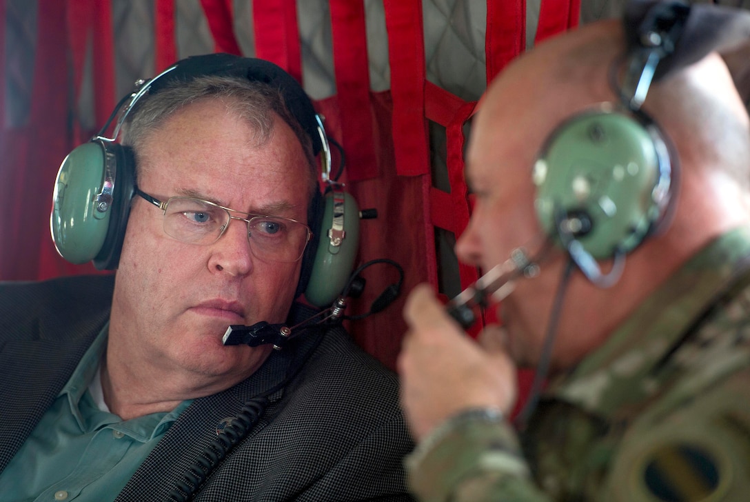 Deputy Defense Secretary Bob Work, left, talks with Army Lt. Gen. Pat