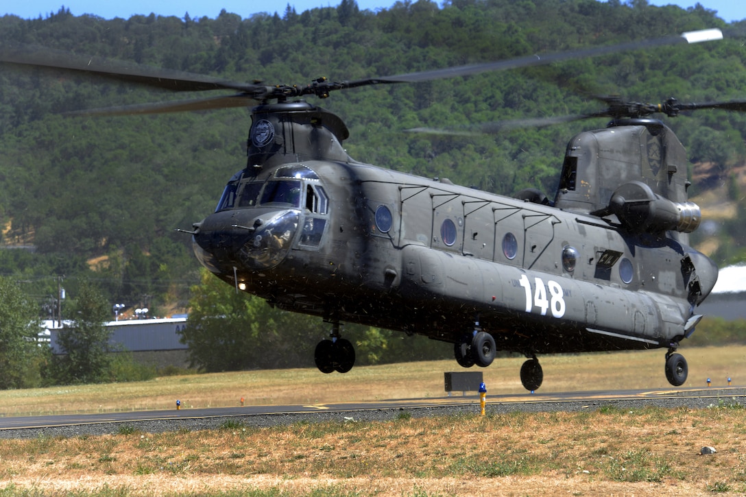 An Oregon Army National Guard CH-47 Chinook helicopter arrives at the Roseburg Municipal Airport in Roseburg, Ore., Aug. 5, 2015. The Chinook and two HH-60M Black Hawk helicopters are working with local, county and state agencies in fire suppression efforts in the Stouts fire near Canyonville, Ore.