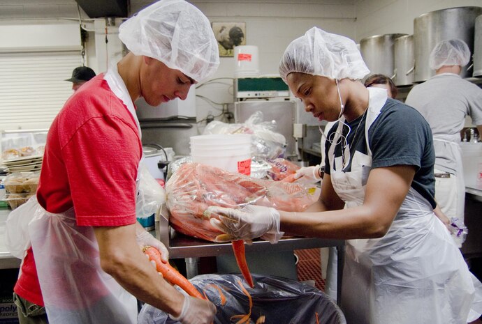 Sgt. Joshua Flores (left), a platoon sergeant with Combat Logistics Battalion 3 and a Boston native, and Cpl. Dominique Craig, a supply clerk with CLB-3 and an Atlanta native, peel carrots in the kitchen at one of the Institute for Human Services’ shelters in Honolulu, Aug. 1, 2015. The Single Marine & Sailor Program regularly volunteers with IHS among other organizations throughout the year. The many volunteer opportunities SM&SP provides fall in line with the mission of Marine Corps Base Hawaii, which is to provide facilities, programs and services in direct support of units, individuals and families in order to enhance and sustain combat readiness for all operating forces and tenant organizations aboard the installation. (U.S. Marine Corps photo by Kristen Wong/Released)