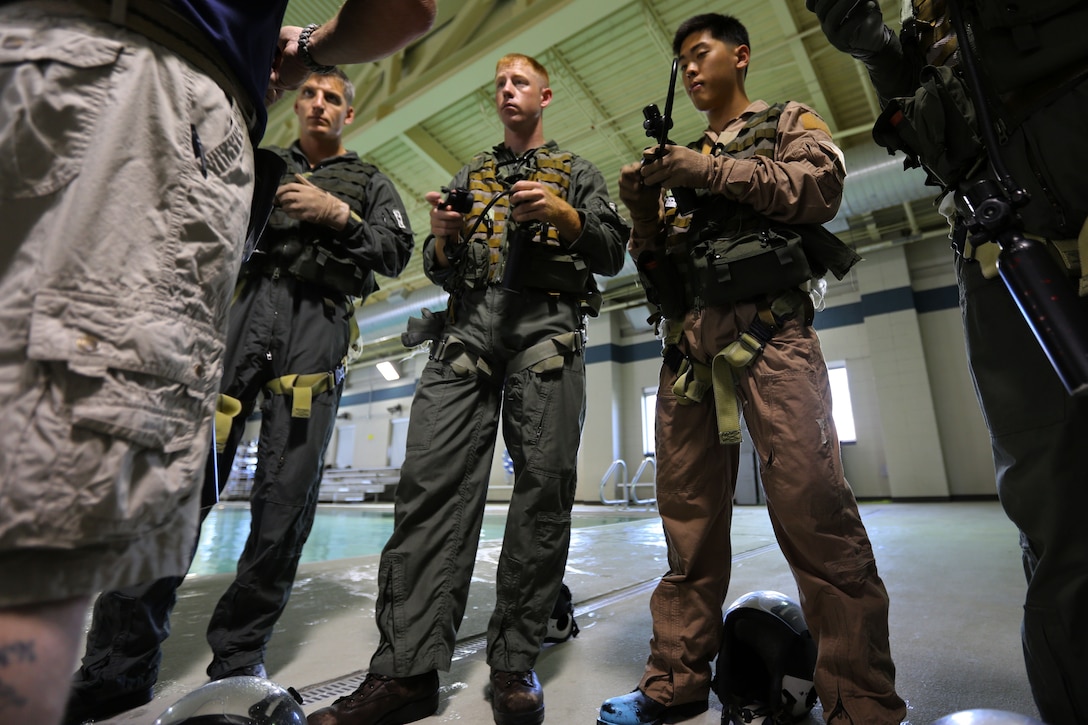 Marines recieve a safety brieff during water survival training at Marine Corps Air Station Cherry Point, North Carolina, July 28, 2015. The Aviation Survival Training Center is the only water survival facility on any Marine Corps installation on the East Coast. Naval aviators are given classes on protocol and the gear they use in case of an emergency on an aircraft. The skills they learn in ASTC ensure 2nd Marine Aircraft Wing, its aviators and crew members are qualified and maintain the highest state of readiness.