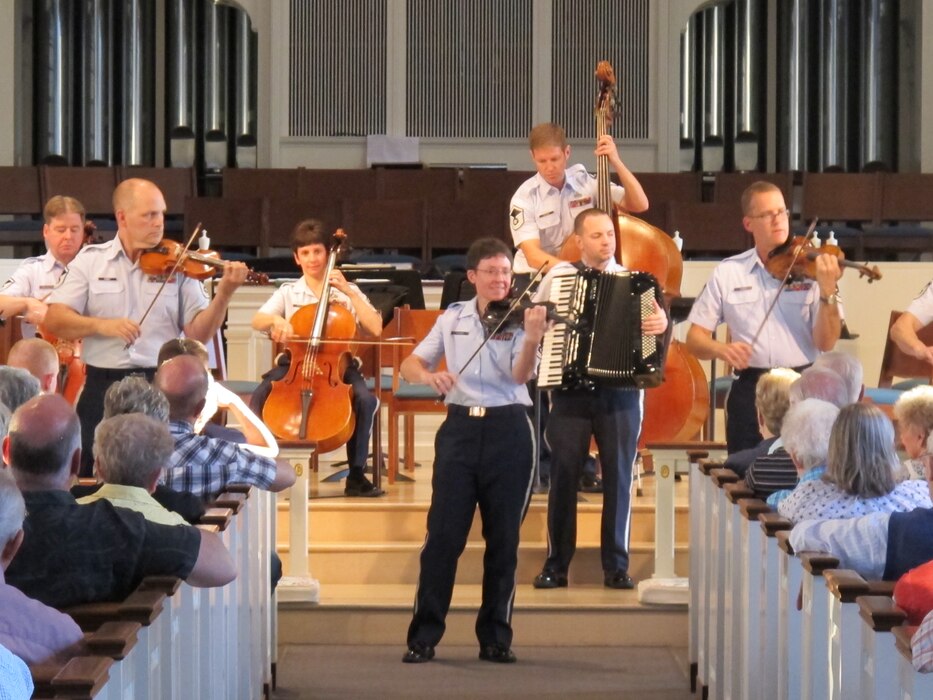 Chief Master Sgt. Deborah Volker leads the Air Force Strings during a
performance in her hometown of Lansdale, Pa. The packed hall enjoyed a wide
variety of music, from classics to popular songs. (Photo by Capt. Joseph
Hansen/released)
