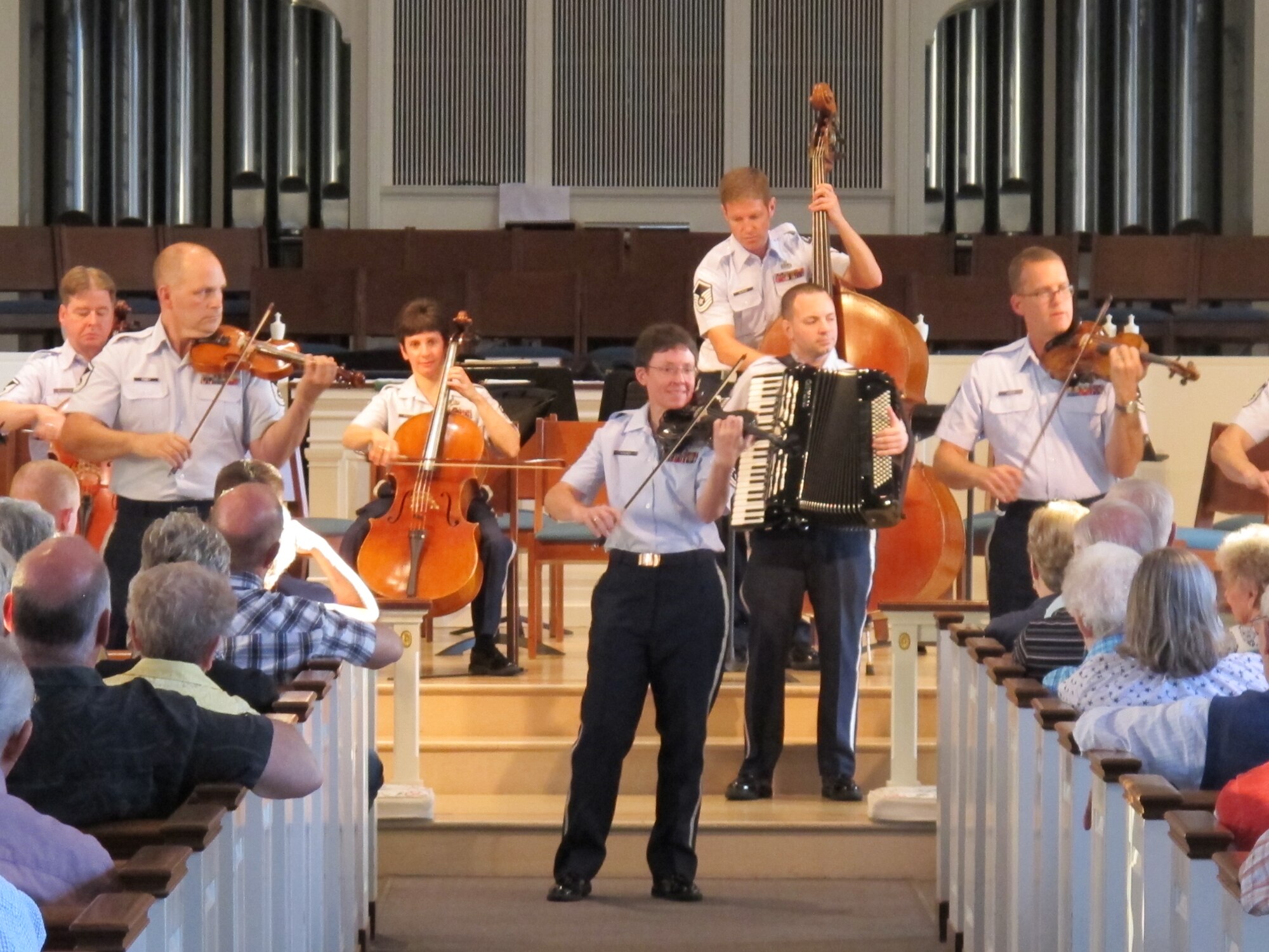 Chief Master Sgt. Deborah Volker leads the Air Force Strings during a
performance in her hometown of Lansdale, Pa. The packed hall enjoyed a wide
variety of music, from classics to popular songs. (Photo by Capt. Joseph
Hansen/released)