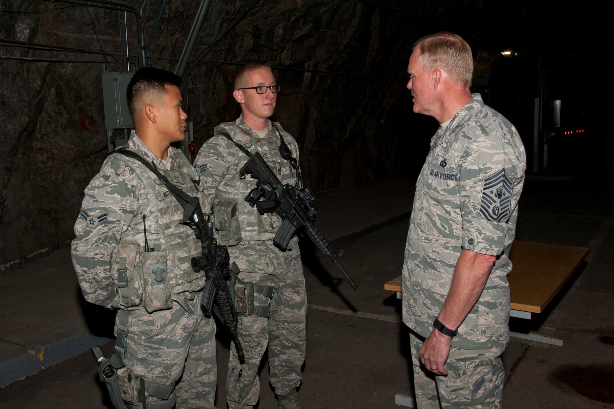 CHEYENNE MOUNTAIN AIR FORCE STATION, Colo. – Chief Master Sgt. of the Air Force James A. Cody talks with two 721st Security Forces Squadron Airmen about their experiences as security forces members and working in the mountain during his visit to Cheyenne Mountain Air Force Station, Aug. 6, 2015. Cody was at CMAFS to visit with Airmen and get his first tour of “America’s Fortress.” He also held an enlisted call to discuss the changes taking place throughout the Air Force and answer any questions. (U.S. Air Force photo by Airman 1st Class Rose Gudex)