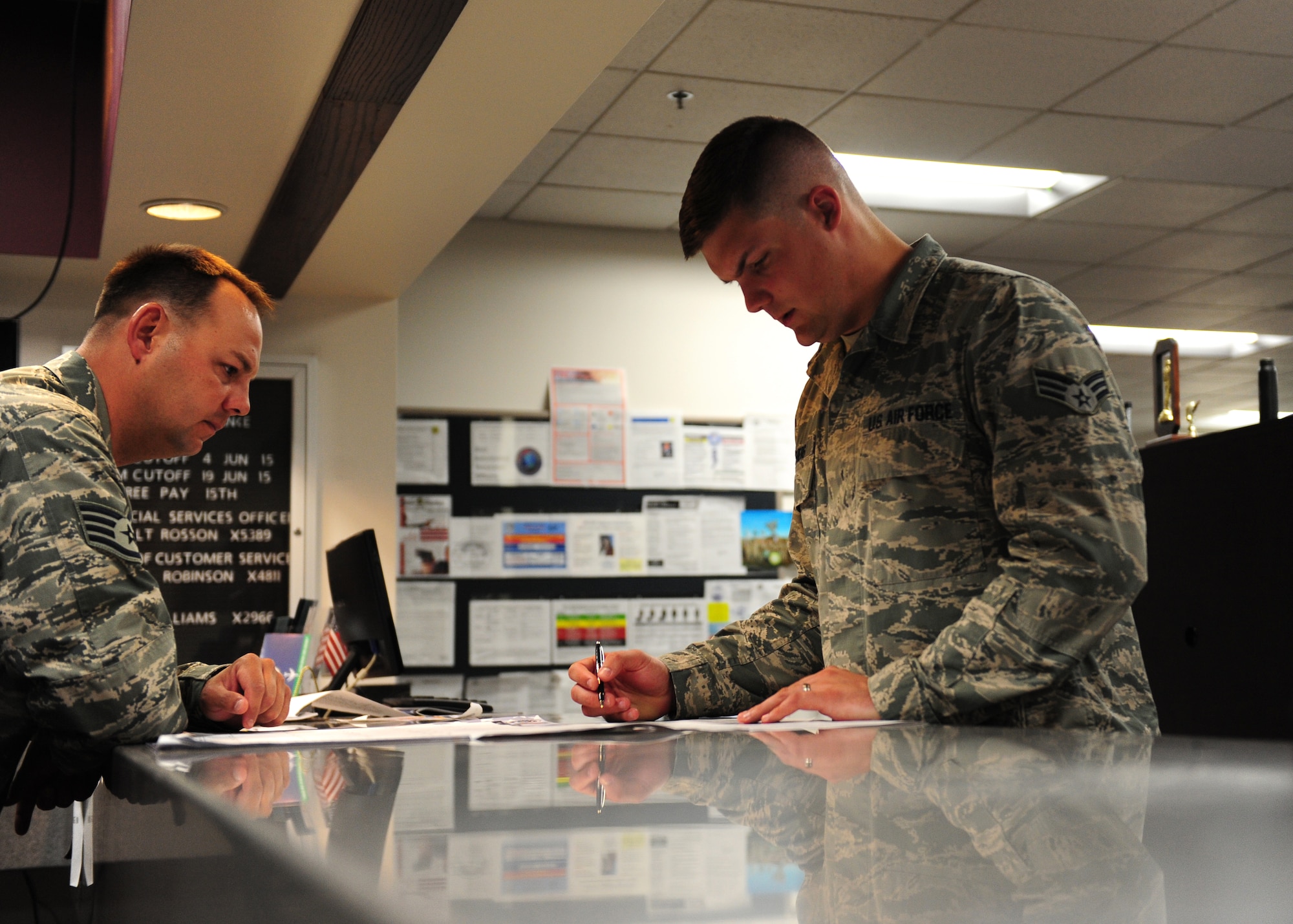 Senior Airman Mason Meherg, 509th Comptroller Squadron financial services technician, in-processes a customer June 18, 2015, at Whiteman Air Force Base, Mo. Meherg was recently named one of 12 Outstanding Airmen of the Year for 2015. (U.S. Air Force photo by Senior Airman Joel Pfiester/Released)
