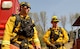 Steven Dobbs (left), 9th Civil Engineer Squadron fire captain, and Airman 1st Class Austin Kauffman, 9th CES firefighter, prepare to assist in a wildfire Aug. 6, 2015, near Clearlake, California. The Rocky Wildfire has consumed nearly 70,000 acres in Northern California. (U.S. Air Force Photo by Airman Preston L. Cherry)