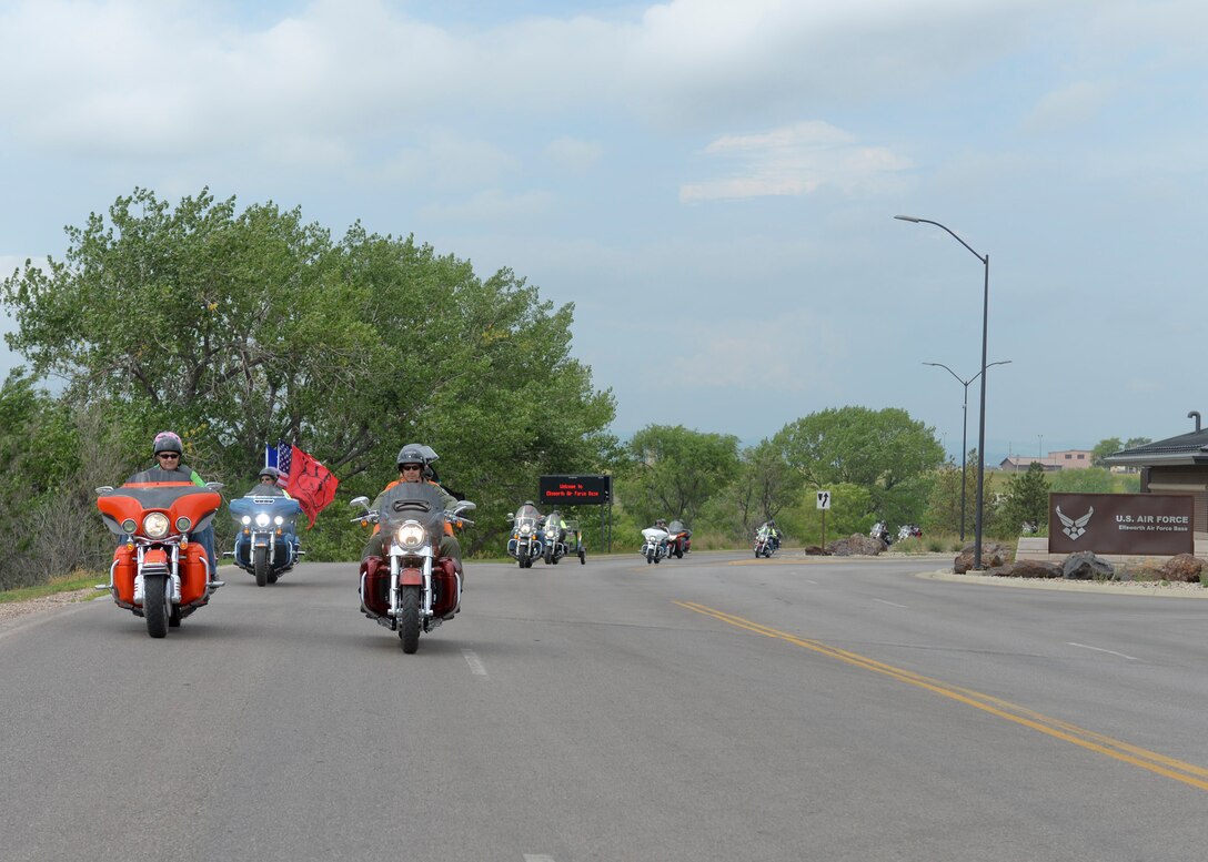 Col. Ty Neuman, 28th Bomb Wing vice commander, leads a pack of riders through the main gates of Ellsworth Air Force Base, S.D., during the 2015 Dakota Thunder Motorcycle Run, Aug. 4, 2015. During the run, more than 200 motorcyclists rode in staggered formation to ensure a safe and enjoyable trip through the Black Hills. (U.S. Air Force photo by Senior Airman Anania Tekurio/Released)