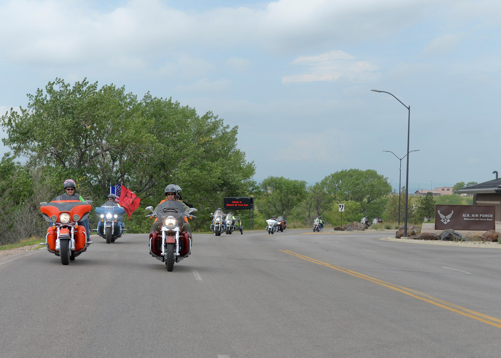 Col. Ty Neuman, 28th Bomb Wing vice commander, leads a pack of riders through the main gates of Ellsworth Air Force Base, S.D., during the 2015 Dakota Thunder Motorcycle Run, Aug. 4, 2015. During the run, more than 200 motorcyclists rode in staggered formation to ensure a safe and enjoyable trip through the Black Hills. (U.S. Air Force photo by Senior Airman Anania Tekurio/Released)
