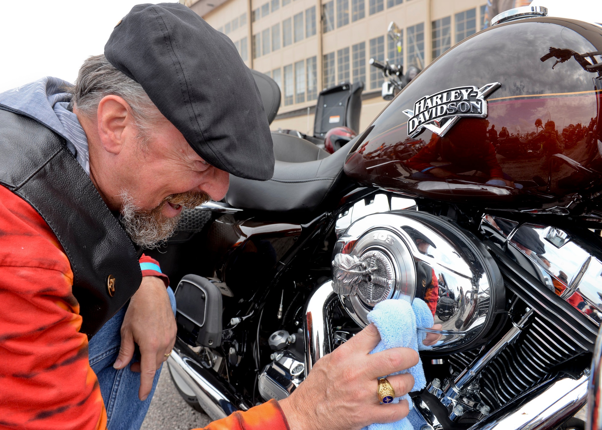 Kevin Goyer, Project Solutions Inc. program manager for Ellsworth, polishes the chrome on his motorcycle during the 2015 Dakota Thunder Motorcycle Run at Ellsworth Air Force Base, S.D., Aug. 4, 2015. Hosted by the Green Knights Dakota Thunder Motorcycle Club, Goyer was one of 200 participants to ride en masse to Sturgis, S.D., where a military appreciation ceremony recognized local veterans and honored military members past and present. (U.S. Air Force photo by Senior Airman Anania Tekurio/Released)