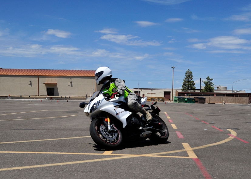 Senior Airman Daniel Keum, 56th Civil Engineer Squadron Explosive Ordnance Disposal technician and Luke motorcycle safety instructor, demonstrates cornering July 28 at the Luke Air Force Base motorcycle riding range. Practicing proper cornering can help with negotiating real-life turns and helps keep the rider safe.