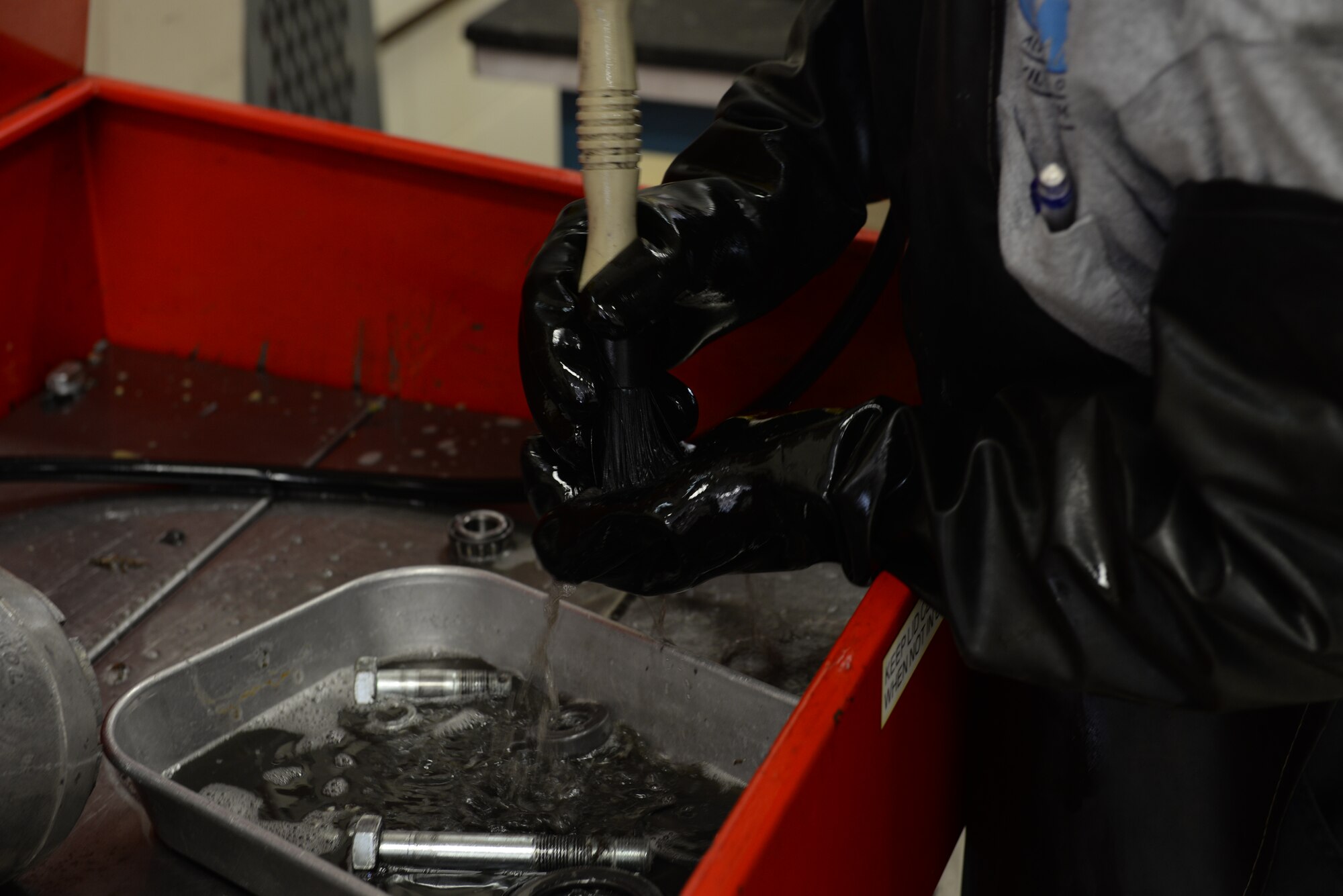 ALTUS AIR FORCE BASE, Okla. – Cal Jones, 97th Maintanence Directorate Aerospace Ground Equipment mechanic, greases parts to an A/C unit in Building 278, Aug. 5, 2015. AGE provided back-up equipment to the aircrew of Air Force One when the president visited Texas in July. (U.S. Air Force photo by Airman 1st Class Kirby Turbak/Released)