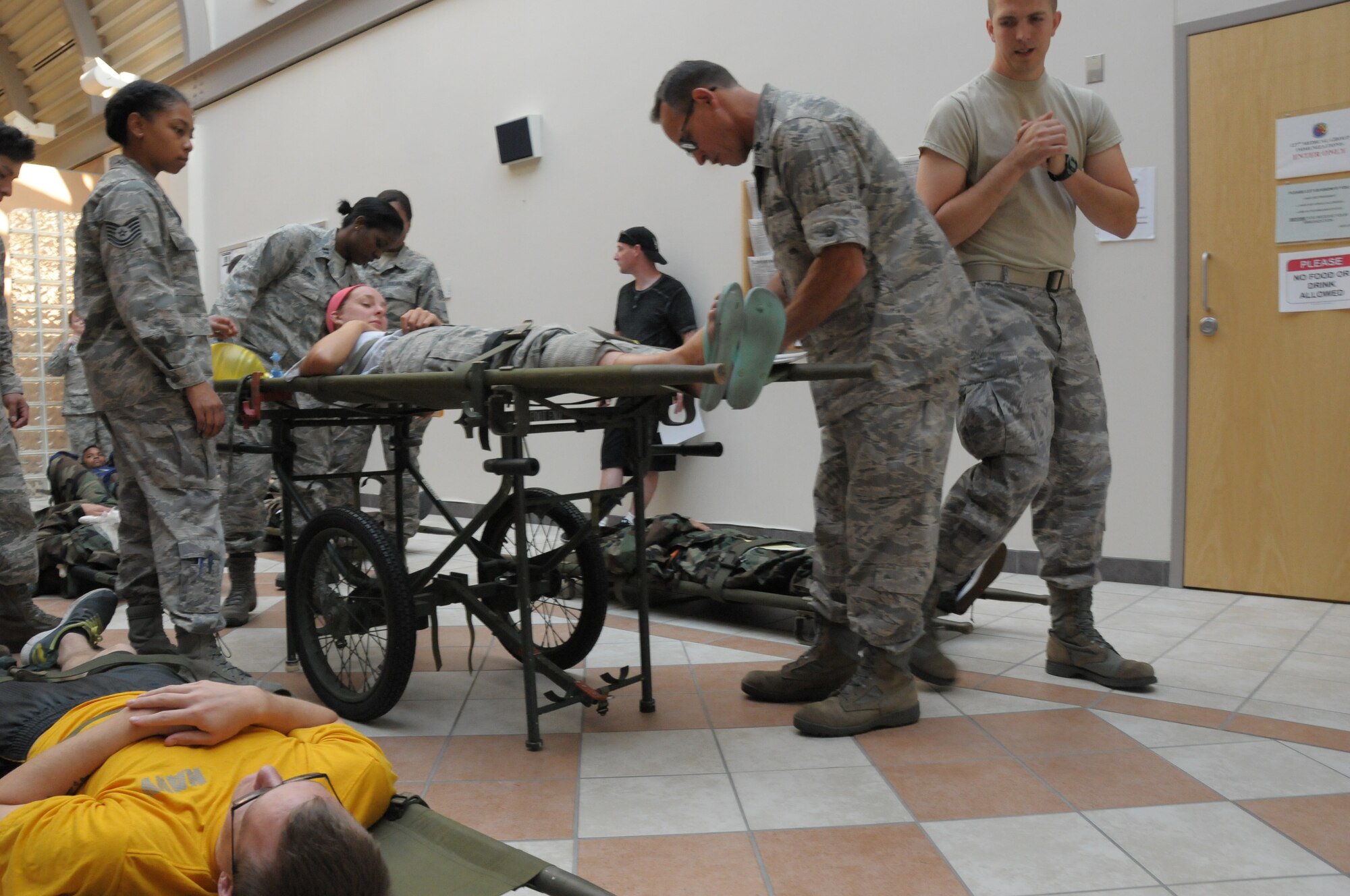 150804-Z-YW189-078 - Several members of the 127th Medical Group, Selfridge Air National Guard Base, prepare “injured “victims to be transported to the hospital, during a mass casualty as a result of an active shooter exercise. The exercise was held to test and evaluate the preparedness of the Medical Group at the Selfridge Air National Guard Base, Mich., Aug. 7, 2015. (U.S. Air National Guard photo by Staff Sgt. Samara Taylor/Released)