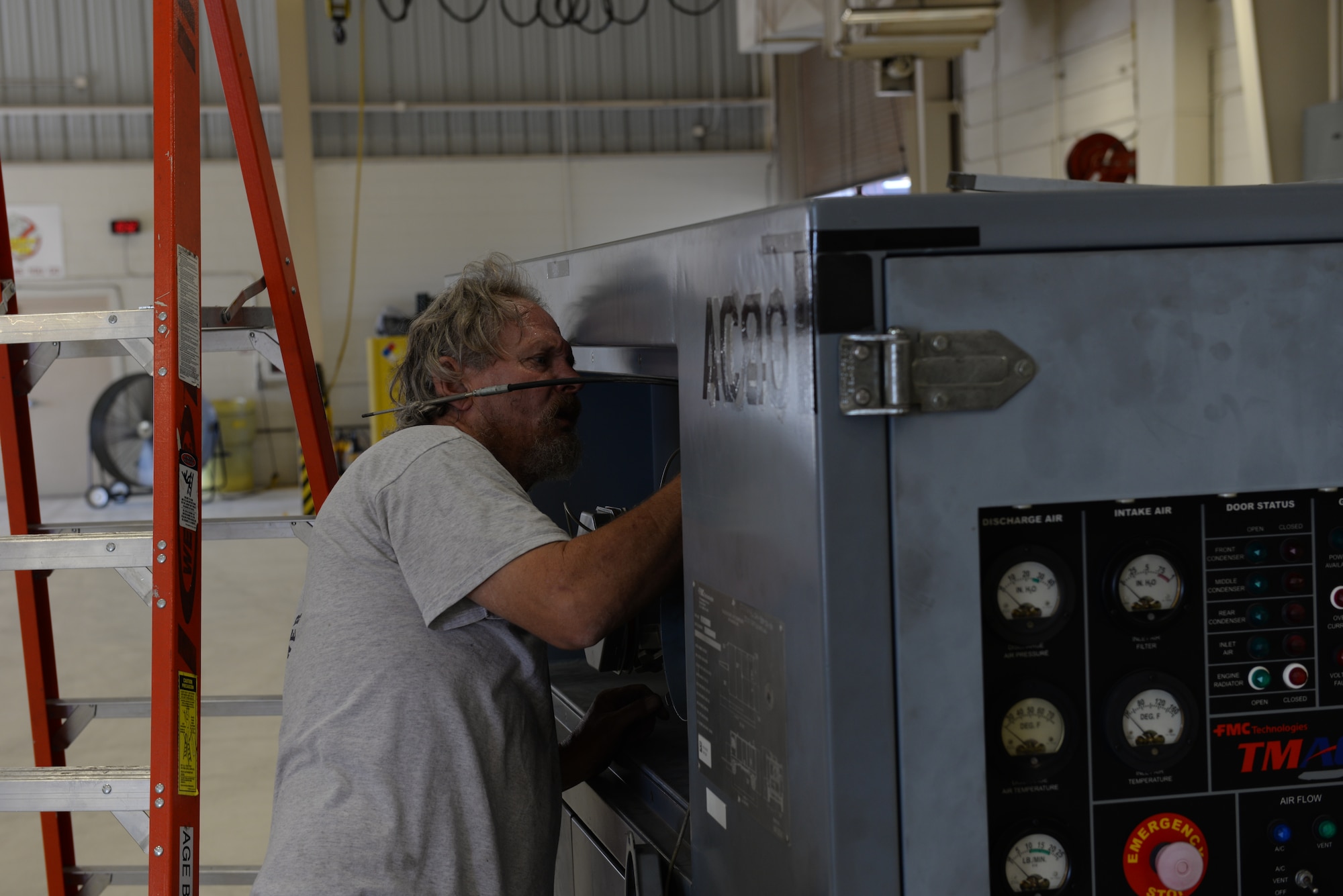 ALTUS AIR FORCE BASE, Okla. – Bob Tiscler, 97th Maintanence Directorate Aerospace Ground Equipment mechanic, works on a portable air conditioning unit in Building 278, Aug. 5, 2015. AGE’s portable A/C units are used for keeping the aircraft cool when they are grounded, but during July, they were used to keep shops cool as their A/C was being fixed. (U.S. Air Force photo by Airman 1st Class Kirby Turbak/Released)