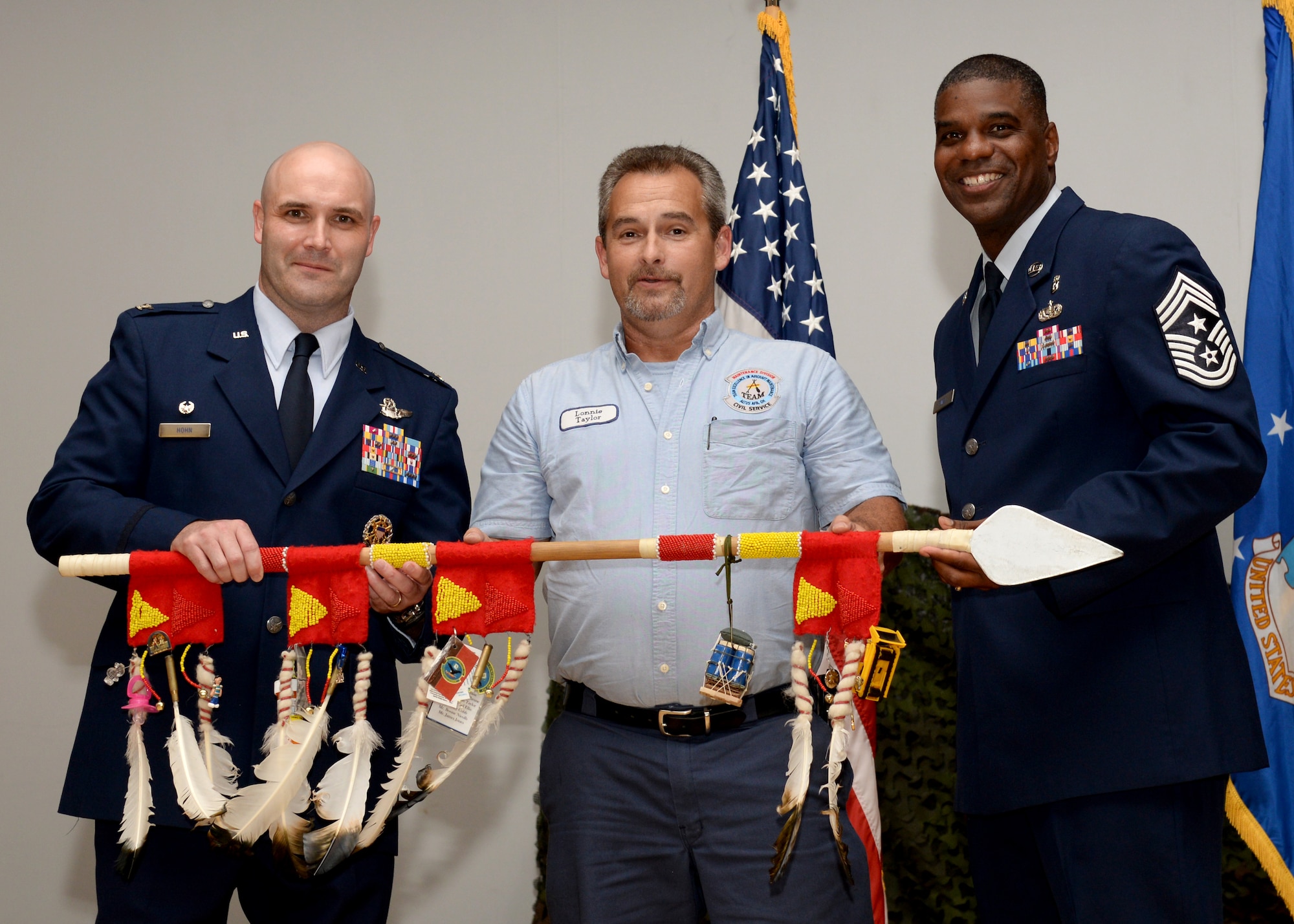 ALTUS AIR FORCE BASE, Okla. – Lonnie Taylor, 97th Maintanence Directorate Aerospace Ground Equipment Flight supervisor, stands with Col. Todd Hohn, 97th Air Mobility Wing commander, and Chief Master Sgt. James Powell III, 97th Air Mobility Wing command chief, at Veteran’s Theater, July 31,2015. Taylor accepted the Flaming Spear award on behalf of the 97th AGE for all the hard work they did during the month of July. (U.S. Air Force photo by Airman 1st Class Kirby Turbak/Released)