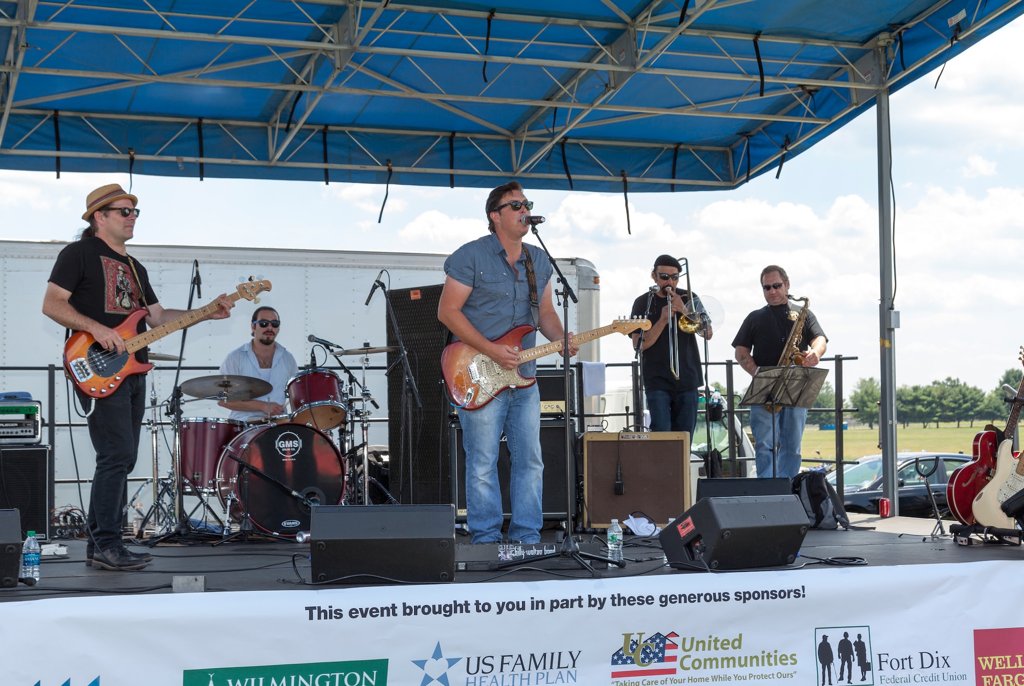 The Billy Walton Band performs a concert for service members and their families at the Red, White and Blues Base-Wide Picnic at Doughboy Field on Joint Base McGuire-Dix-Lakehurst, N.J., Aug. 5, 2015. The picnic featured face painters, games, bounce houses, free food and included a concert by the Billy Walton Band. (U.S. Air Force photo by Joe Sharp/Released)