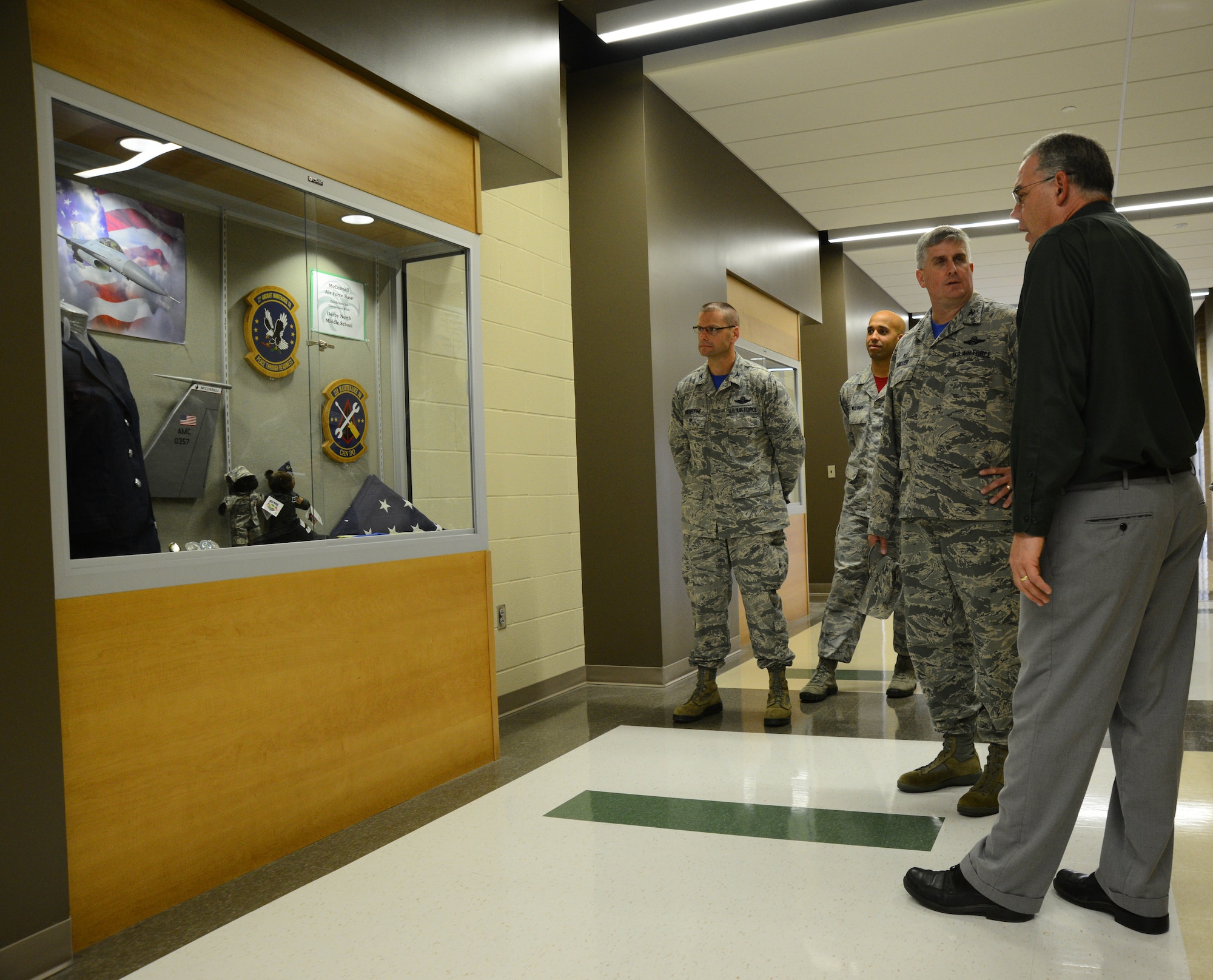 Jeff Smith, Derby North Middle School principal, shows an Air Force display to Col. Albert Miller, 22nd Air Refueling Wing commander, Aug. 7, 2015, at the school in Derby, Kan. McConnell leadership visited the school to see how the community assists service members’ children. (U.S. Air Force photo by Airman 1st Class Christopher Thornbury)