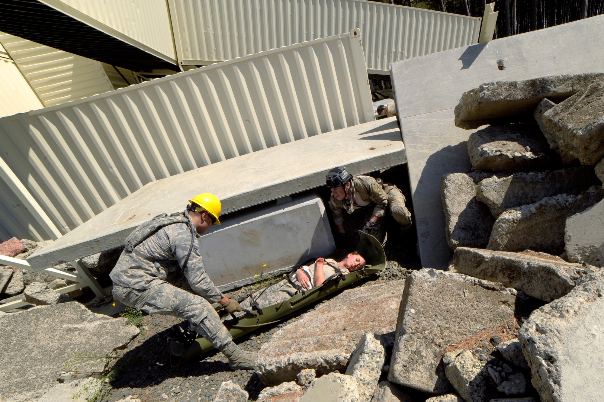 First responders assist a survivor out of a simulated damaged structure during Pathfinder-Minutemen Exercise, Aug. 5, 2015 at Camp Rilea in Warrenton, Ore. The annual event is a joint multi-agency, multi-state disaster preparedness exercise based on response to a possible Cascadia Subduction Zone event. Officials believe the Northwest is overdue for a magnitude 7.0 or greater earthquake. (U.S. Air National Guard photo by Tech. Sgt. John Hughel, 142nd Fighter Wing Public Affairs/Released)
