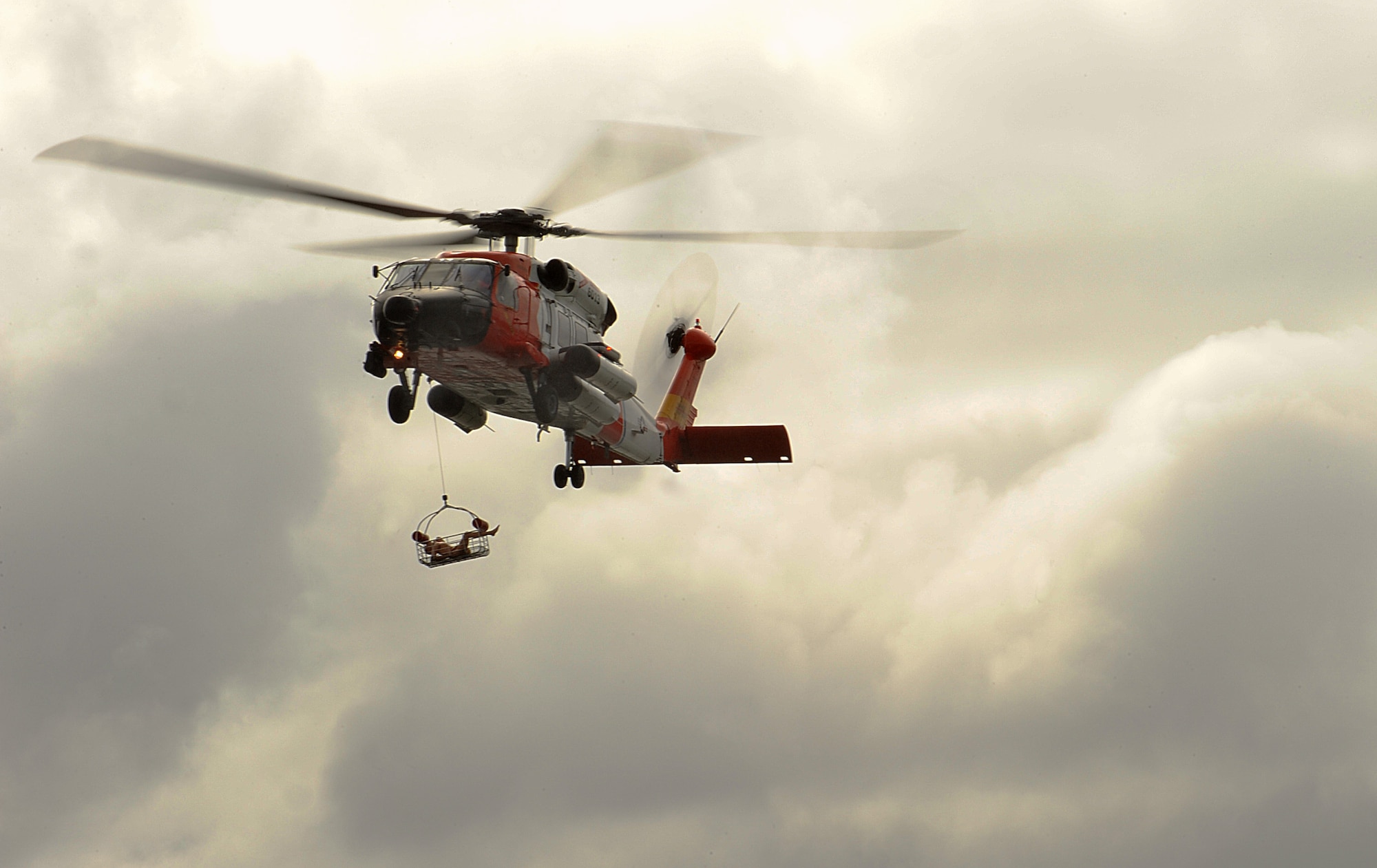 A U.S. Coast Guard HH-60 Jayhawk helicopter, from Air Station Astoria, retrieves a simulated victim from Slusher Lake at Camp Rilea, in Warrenton, Oregon, during the Pathfinder-Minutemen Exercise, Aug. 5, 2015 at Camp Rilea in Warrenton, Ore. The annual event is a joint multi-agency, multi-state disaster preparedness exercise based on response to a possible Cascadia Subduction Zone event. Officials believe the Northwest is overdue for a magnitude 7.0 or greater earthquake. (U.S. Air National Guard photo by Tech. Sgt. John Hughel, 142nd Fighter Wing Public Affairs/Released)
