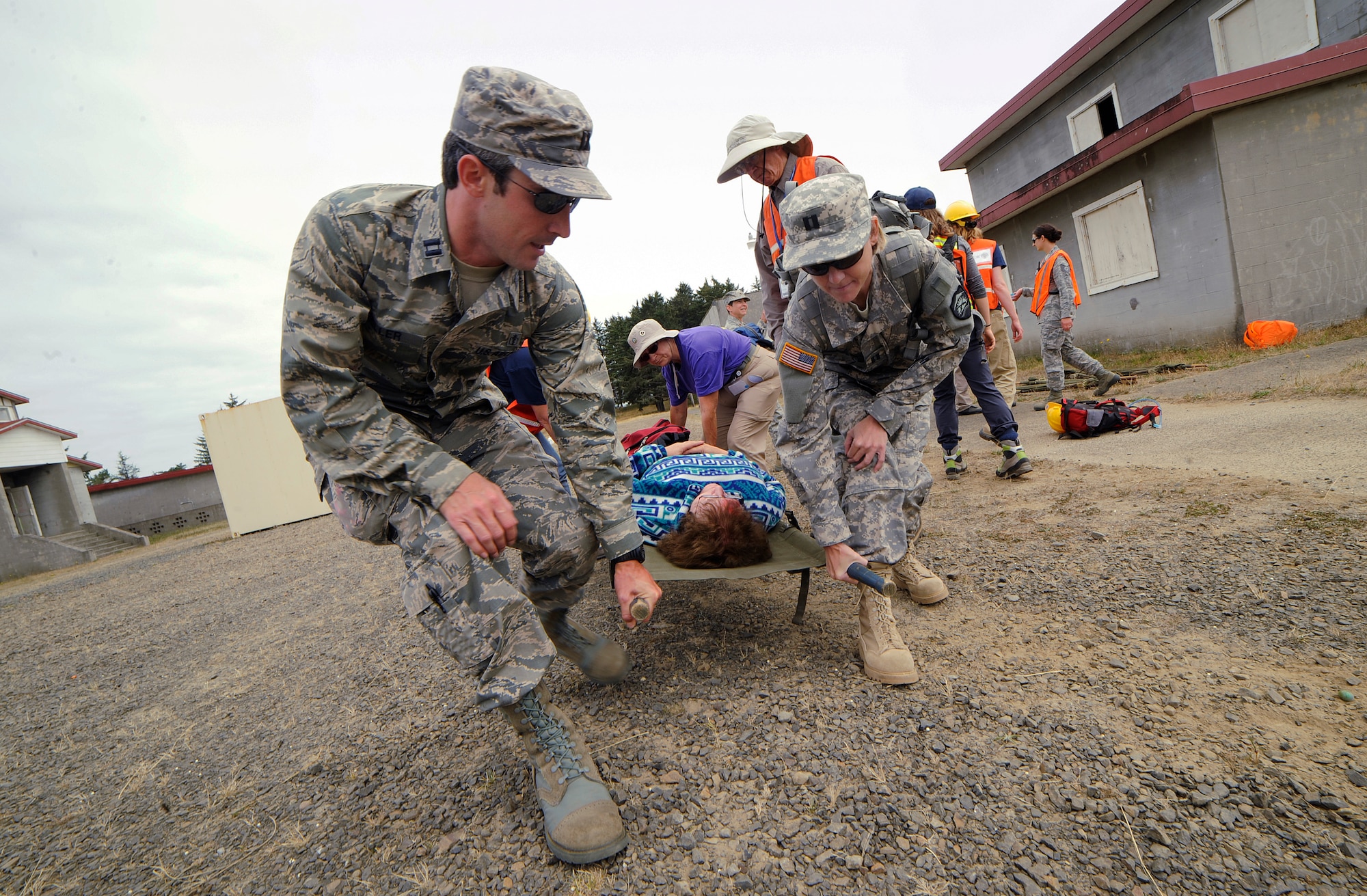 Capt. Jonathon Miller, with the 124th Fighter Wing Medical Group, Idaho Air National Guard, left, and Oregon Army National Guard Capt. Amy Kerfoot, right, lift a simulated casualty during Pathfinder-Minutemen Exercise Aug. 5, 2015 at Camp Rilea in Warrenton, Oregon. The event is a joint multi-agency, multi-state disaster preparedness exercise based on response to a possible Cascadia Subduction Zone event. Officials believe the Northwest is overdue for a magnitude 7.0 or greater earthquake. (U.S. Air National Guard photo by Tech. Sgt. John Hughel, 142nd Fighter Wing Public Affairs/Released)