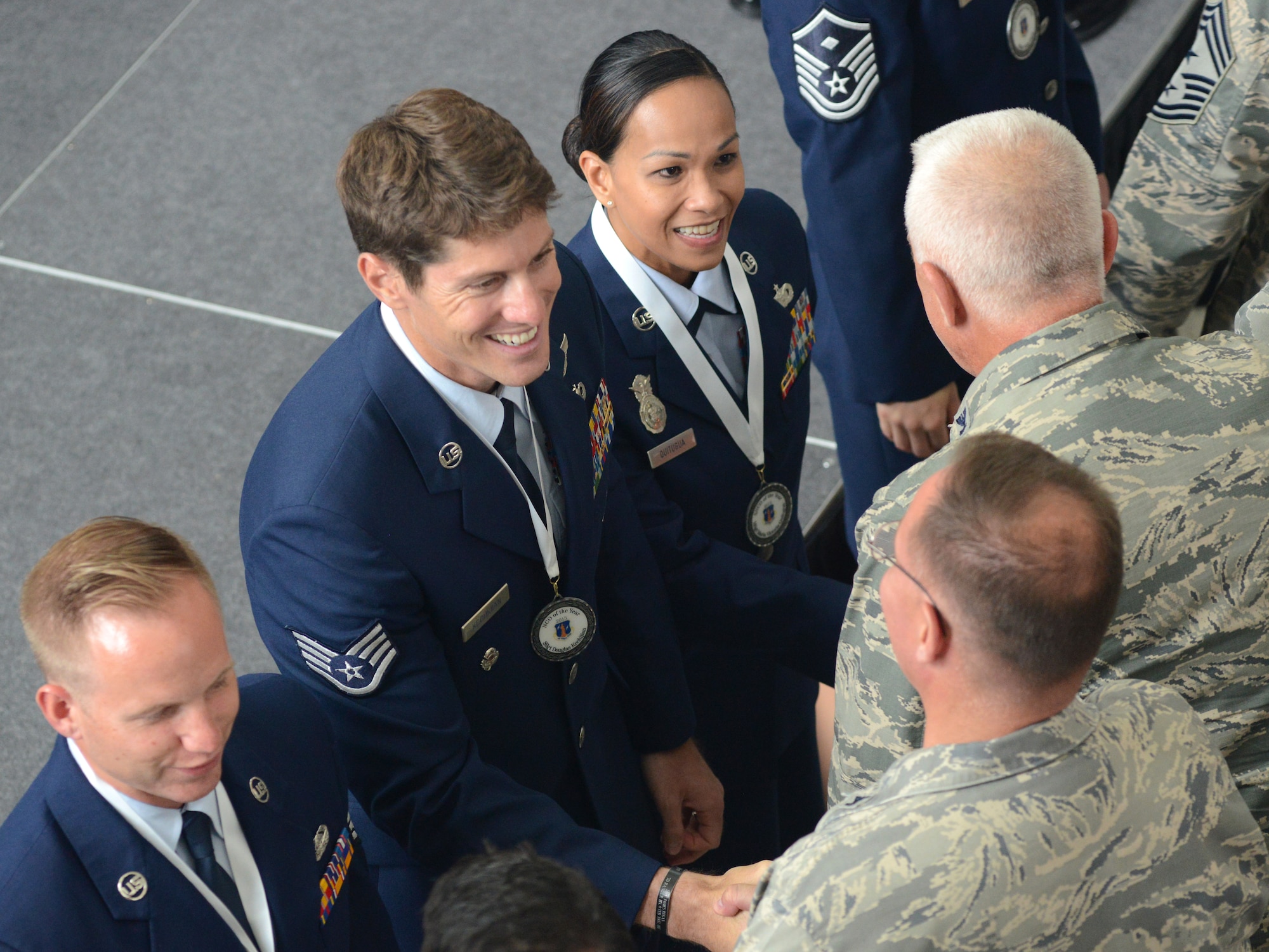 Airmen at the Air National Guard Readiness Center congratulate the Air National Guard 2015 Outstanding Airmen of the Year following an all call hosted by Director of the Air National Guard Lt. Gen. Stanley E. Clarke III at the ANGRC Aug. 6, 2015. The all call was the culmination of Focus on the Force Week, a series of events highlighting the importance of professional development for Airmen at all levels, and the recognition of accomplishments throughout the enlisted corps. (U.S. Air National Guard photo by Staff Sgt. John E. Hillier/released)