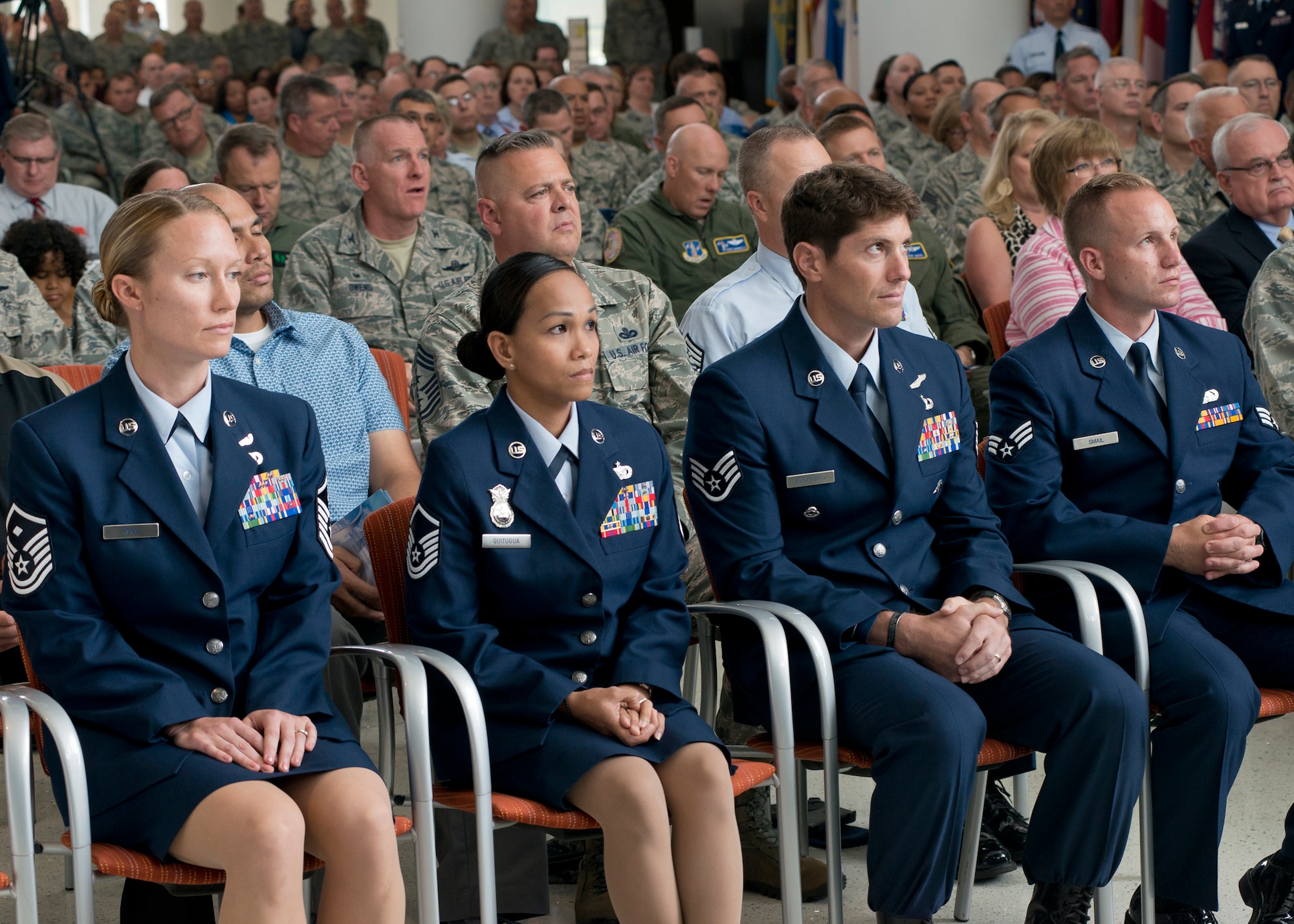 The Air National Guard 2015 Outstanding Airmen of the Year listen as Lieutenant Gen. Stanley E. Clarke III, director of the Air National Guard, addresses the audience during an All Call event at Joint Base Andrews Md., Aug 6, 2015. The OAY winners are (left to right) Master Sgt. Sally J. Ford, Outstanding First Sergeant of the Year, Master Sergeant Maria Victoria R. Quitugua, Outstanding Senior NCO of the Year, Staff Sgt. Douglas P. Kechijian, Outstanding Non-Commissioned Officer of the Year and Senior Airman Jonathan R. Smail, Outstanding Airman of the Year. (Air National Guard photo by Master Sergeant Marvin. R. Preston, Released)