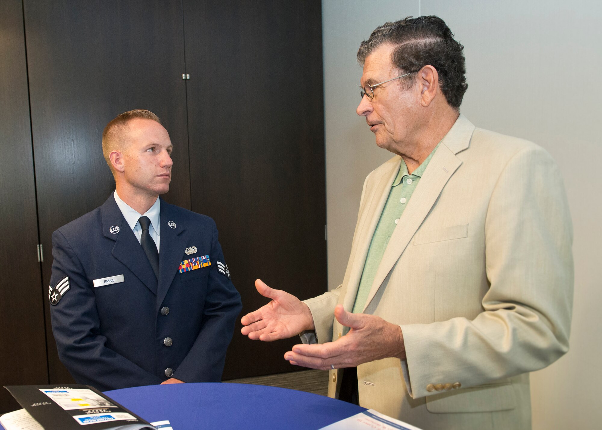 Senior Airman Jonathan R. Smail, Air National Guard 2015 Outstanding Airman of the Year, talks with retired Chief Master Sgt. Lynn E. Alexander, the second Senior Enlisted Advisor of the ANG, at the Air National Guard Readiness Center on Joint Base Andrews, Md., Aug. 6, 2015. Smail is a RF Transmissions Systems Journeyman with the Colorado ANG's 233rd Space Communications Squadron, based in Greeley, Colorado. Focus on the Force week gathers senior enlisted leaders to highlight the importance of professional development at all levels, receive feedback from junior enlisted Airmen, and tell the exceptional stories of ANG Airmen throughout the 50 states, territories, and the District of Columbia. (Air National Guard photo by Master Sergeant Marvin. R. Preston, Released)