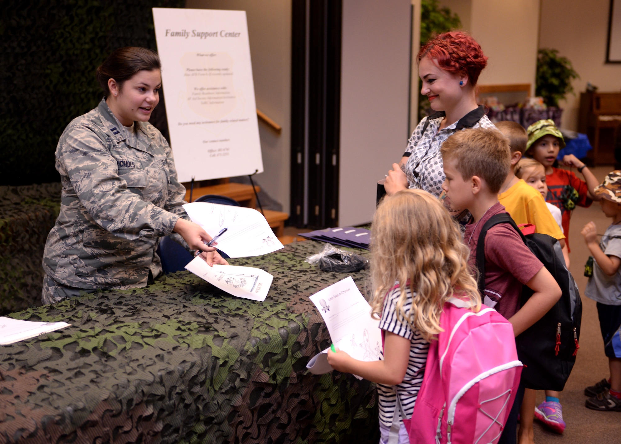 ALTUS AIR FORCE BASE, Okla. – U.S. Air Force Capt. Lauren Nichols, 97th Air Mobility Wing Legal Office chief of civil law, gives a mock legal briefing to dependent children participating in Operation Deploying Family at the Freedom Community Center, Aug. 5, 2015. As each child moved through the mock mobility line, different agencies signed them off on their individual deployment checklists. (U.S. Air Force photo by Airman 1st Class Megan E. Acs/Released) 